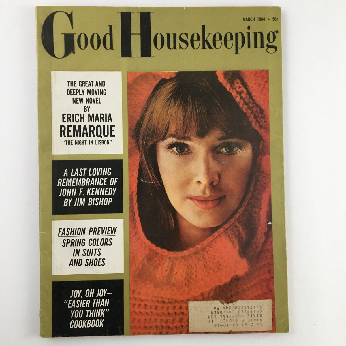Good Housekeeping Magazine March 1964 cover featuring a woman in a red knitted hood and a memorial to John F. Kennedy.
