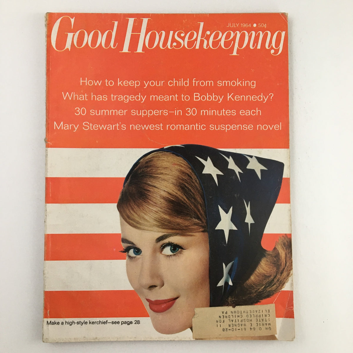 Cover of Good Housekeeping Magazine July 1964 featuring promotional text about parenting, a suspense novel by Mary Stewart, and a stylized model in a star-patterned head scarf.