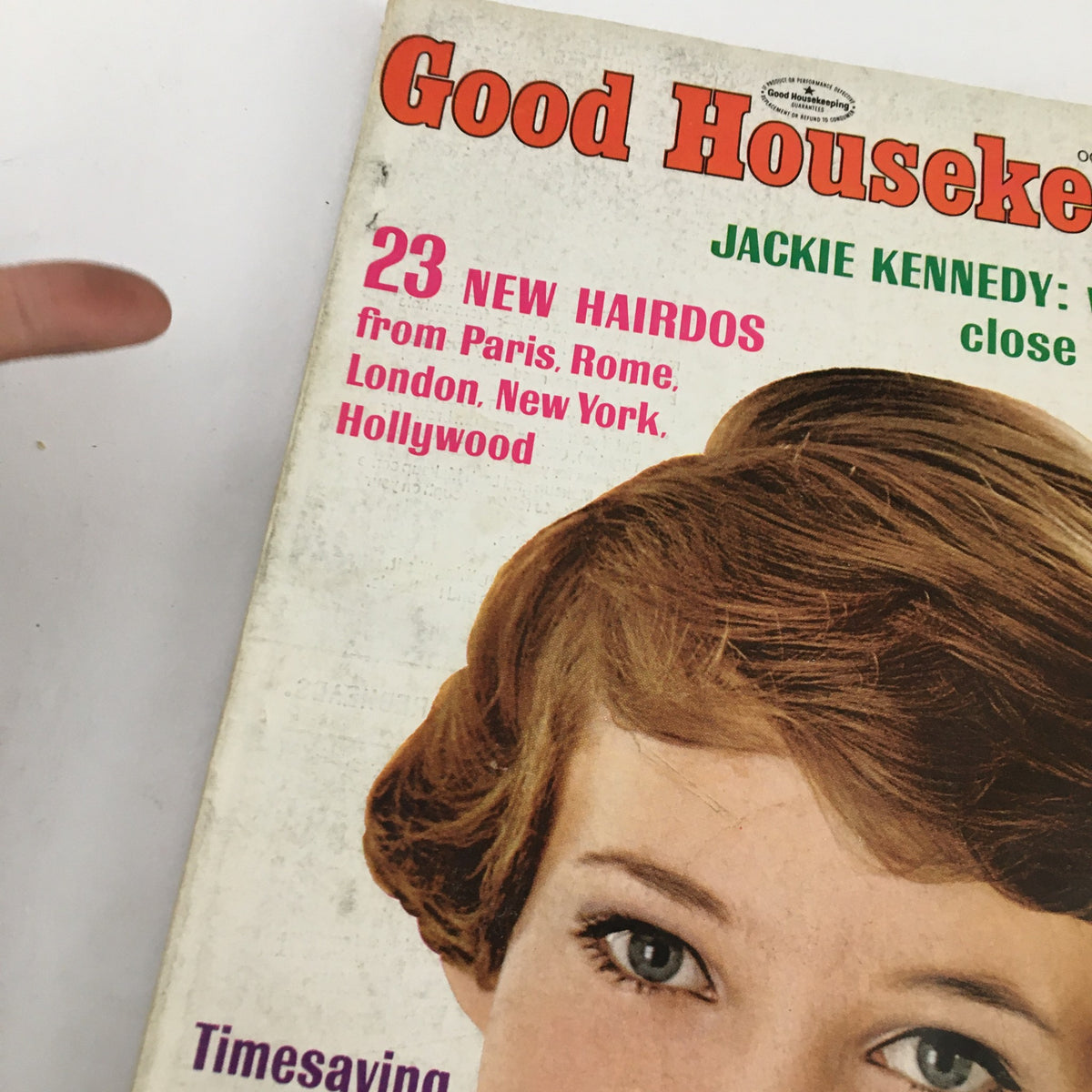 Close-up view of the cover of Good Housekeeping Magazine October 1967, highlighting Jackie Kennedy and the features about new hairstyles from major cities.