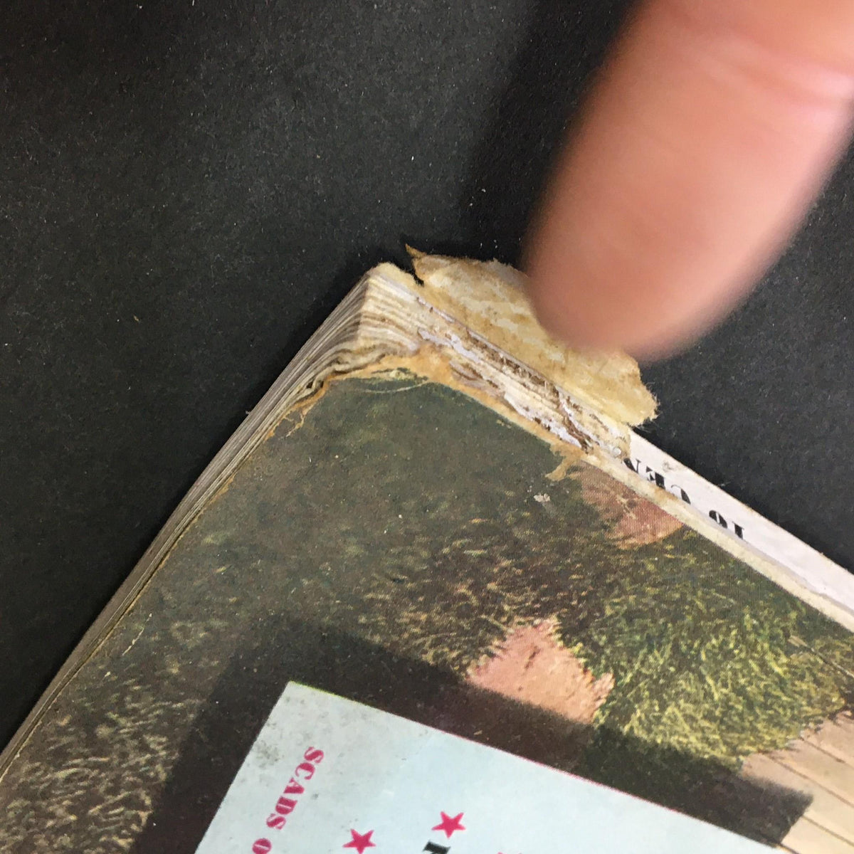 Image capturing the spine of the VTG Better Homes & Gardens May 1941 Extra Sparkle For Your Summer Meals, with visible wear and a finger pointing at the edge.