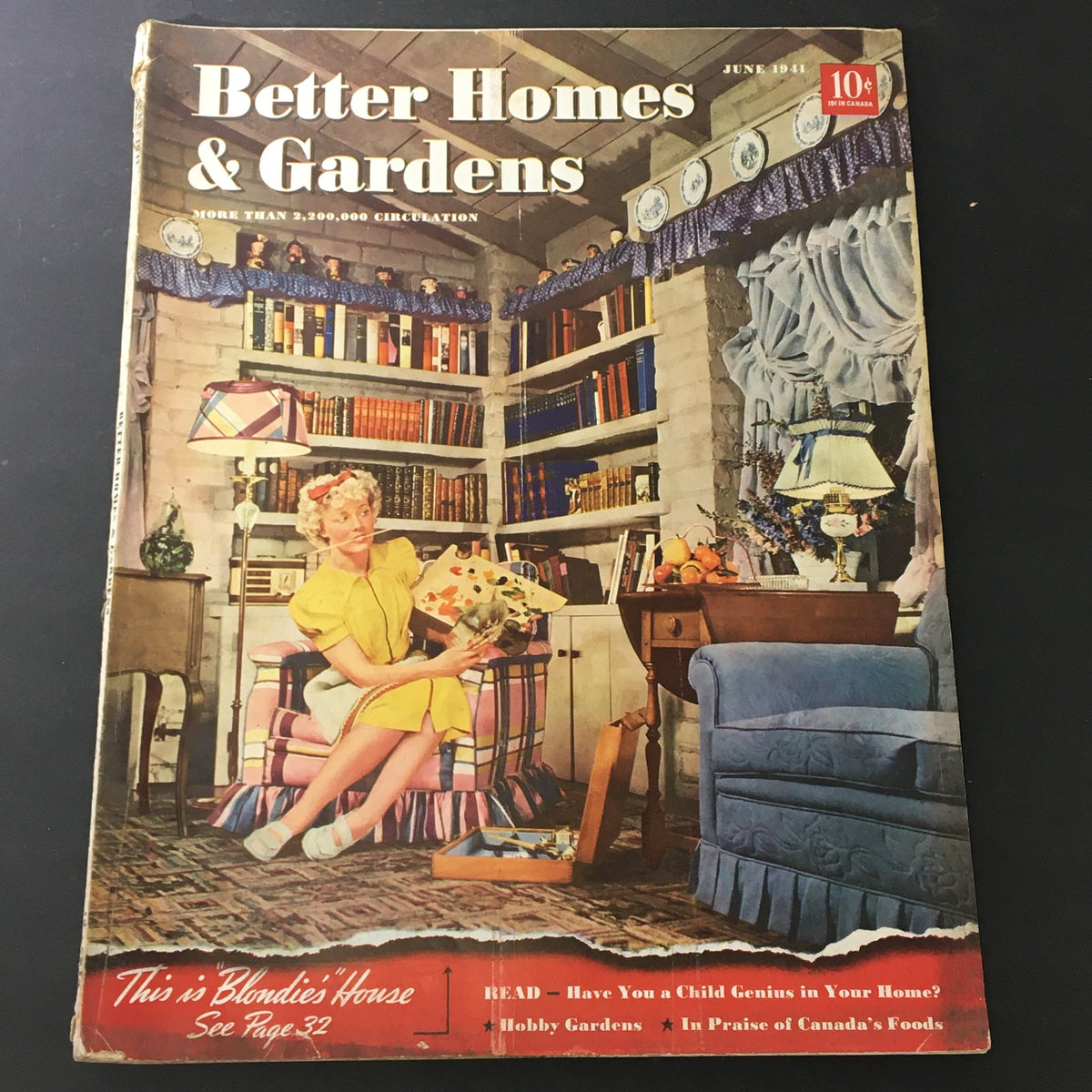 Better Homes & Gardens June 1941 magazine cover featuring a woman in a yellow dress sitting in a cozy corner with bookshelves, reflecting vintage home decor and gardening themes.