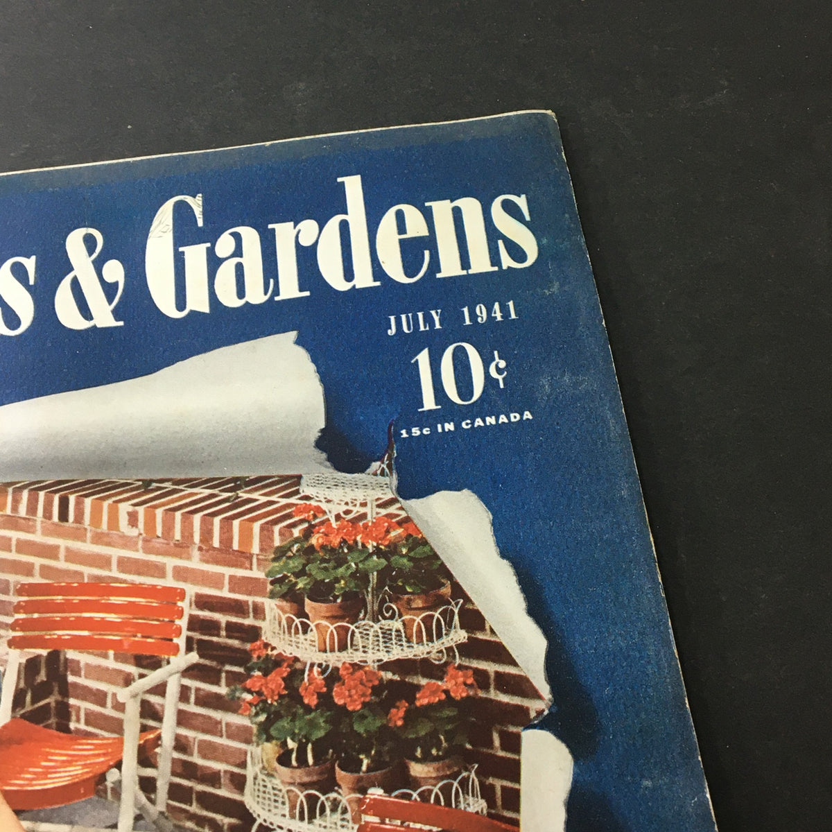 Detail view of the cover from VTG Better Homes & Gardens July 1941, showcasing the magazine's title and price, with a garden background.