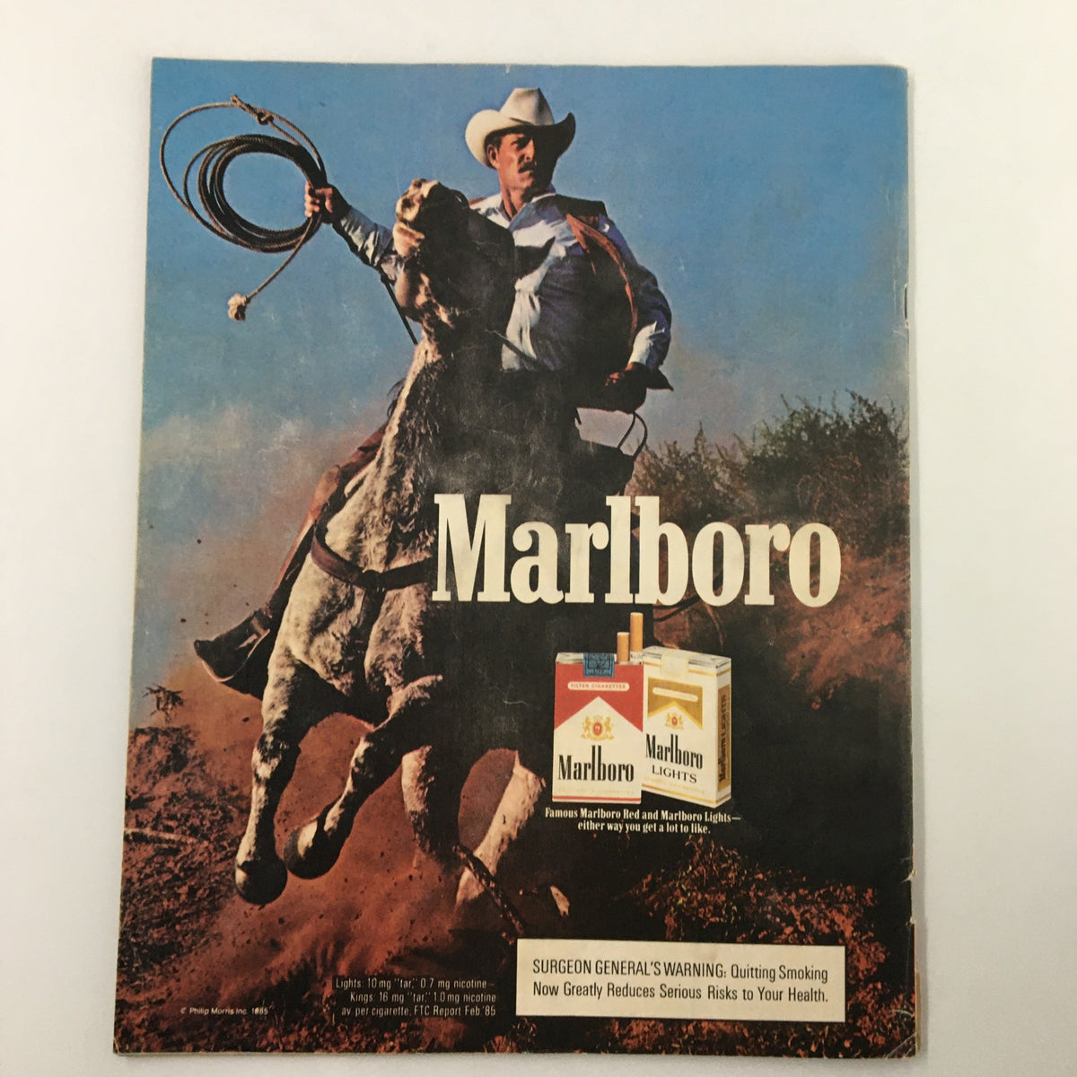 1986 Official Scorebook & Souvenir Program MLB New York Yankees Don Mattingly vintage magazine cover featuring a cowboy holding a lasso against a blue sky background.