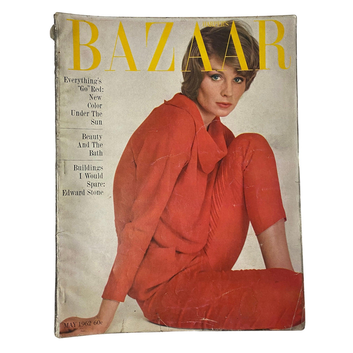 Cover of Harper's Bazaar Magazine May 1962 featuring a model in a red outfit. The magazine highlights summer fashion with articles on vibrant colors and beauty tips.