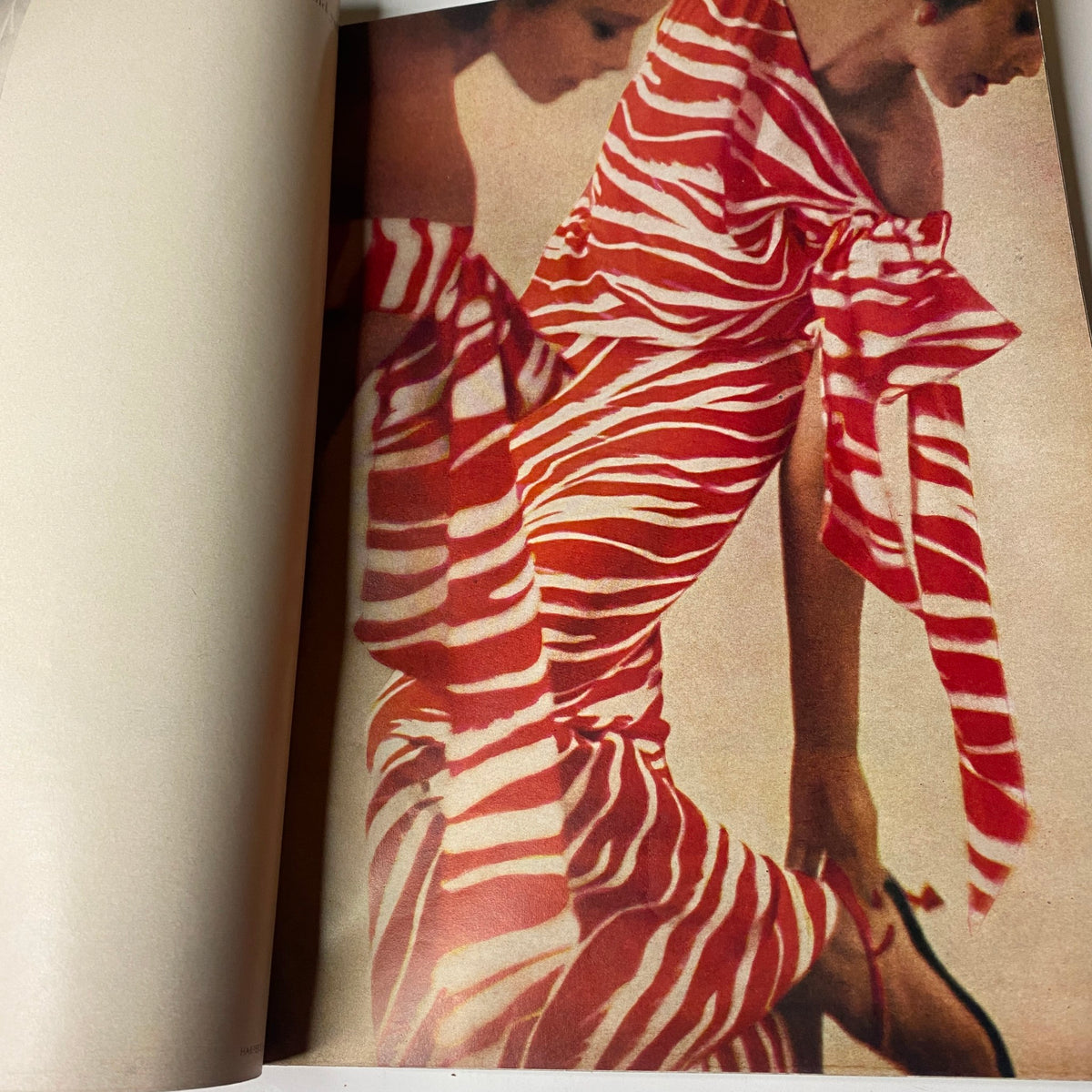 Fashion photograph from Harper's Bazaar Magazine May 1962, showcasing a model in a bold striped dress, capturing the vibrant color palette and unique styles of the season.