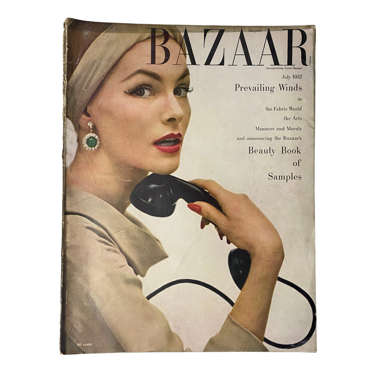 Cover of Harper's Bazaar Magazine July 1952 featuring Georgia Hamilton, photographed by Richard Avedon, showcasing a vintage fashion aesthetic with a model holding a telephone and wearing striking vintage jewelry.