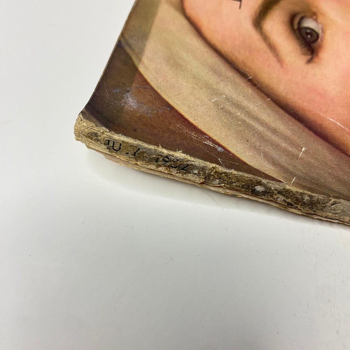 Detail of the spine showing wear and a partially visible date in the Harper's Bazaar Magazine July 1952 Georgia Hamilton Cover by Richard Avedon.