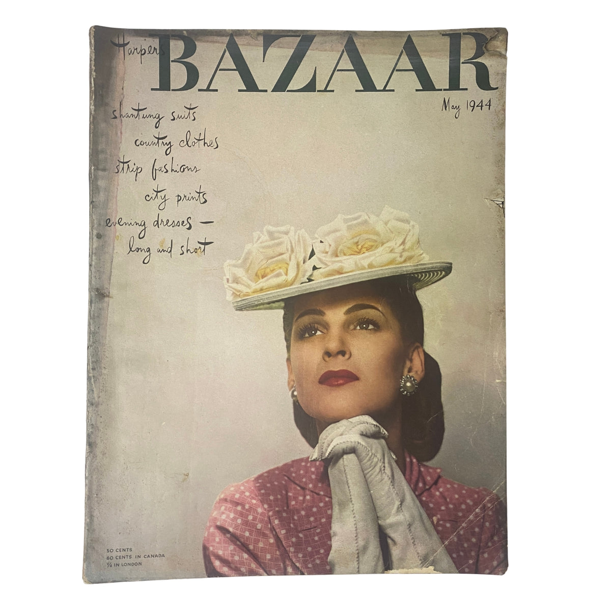 Cover of Harper's Bazaar Magazine May 1944 featuring a model in a floral hat and pink polka dot dress, highlighting the fashion of the era.