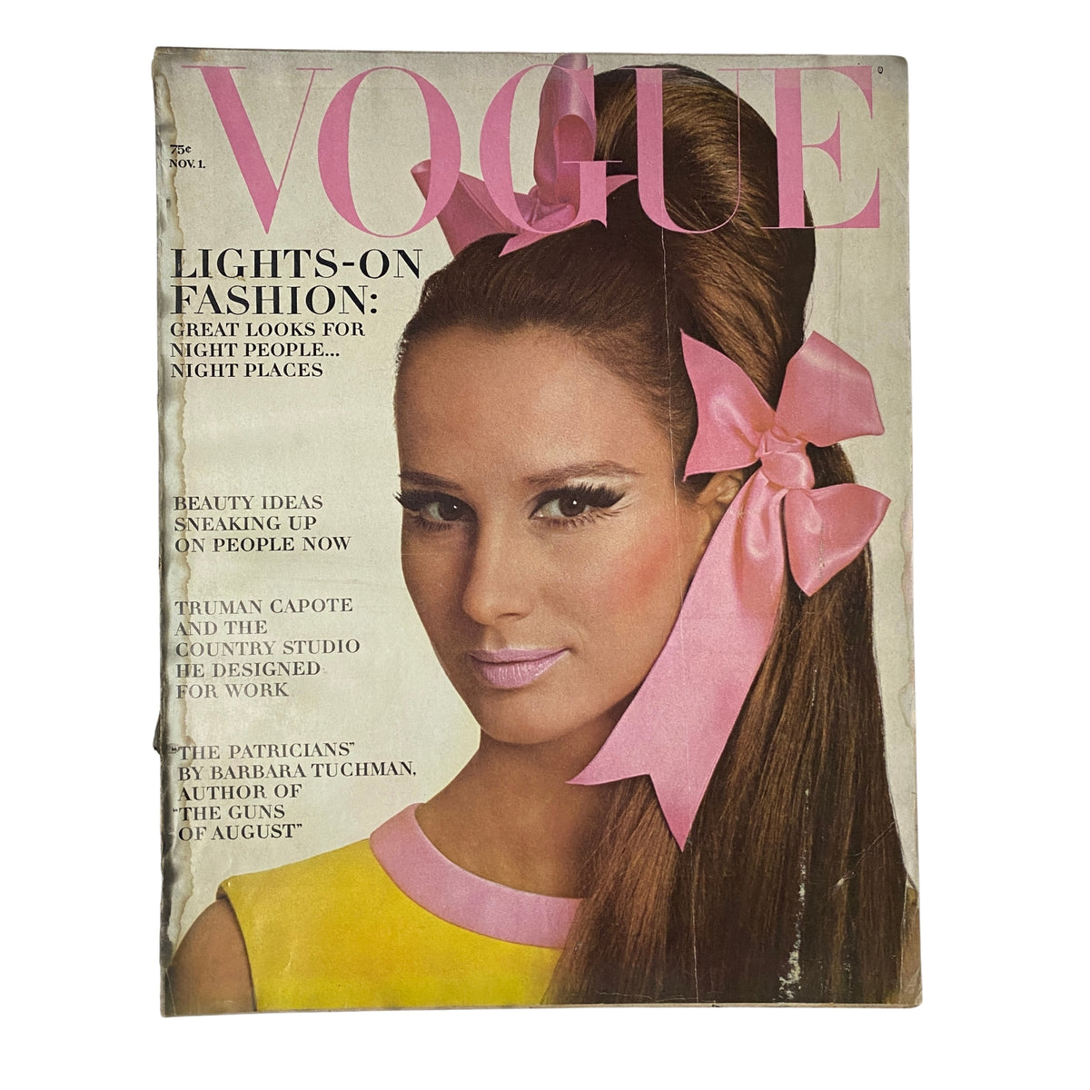 Vogue Magazine cover from November 1, 1965 featuring Brigitte Bauer, photographed by Irving Penn. The cover displays a model with a high hairdo and pink bow, promoting 'Lights-On Fashion' with an emphasis on great looks for night people.