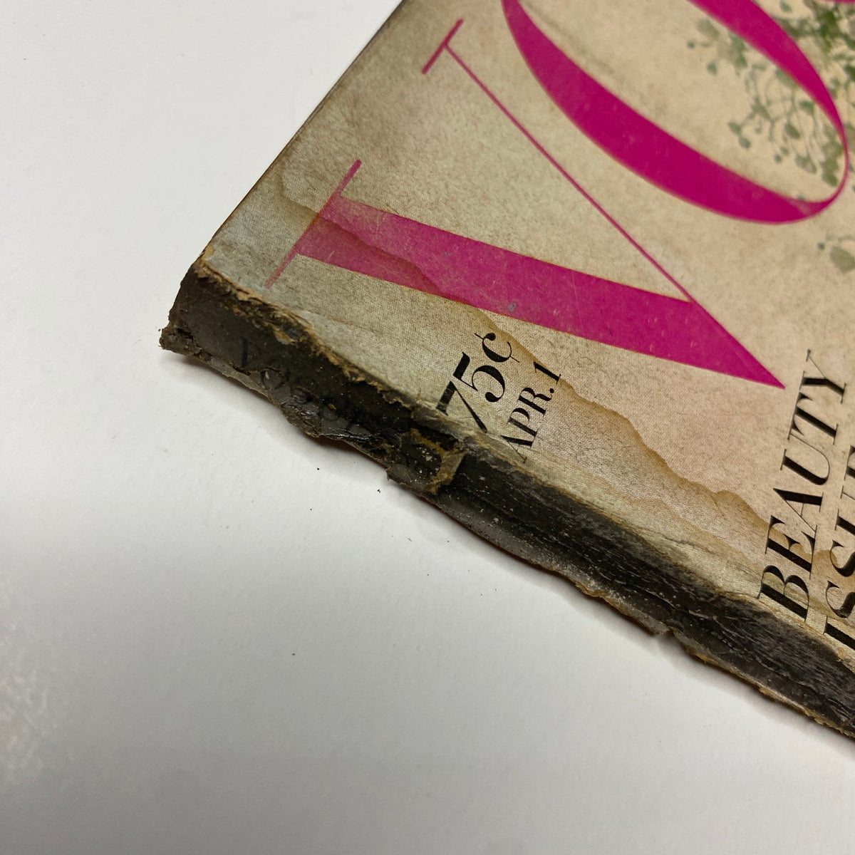 Close-up view of the worn spine of Vogue Magazine April 1, 1968 Veruschka Cover by Irving Penn, illustrating vintage wear with visible damage and age.