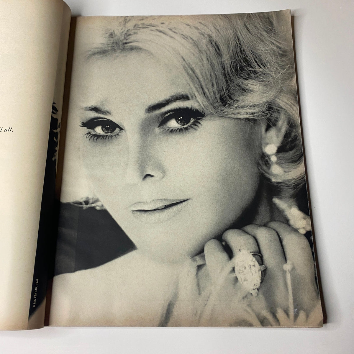 Close-up portrait of a model featured in Vogue Magazine December 1969, emphasizing beauty and elegance alongside a decorative background.