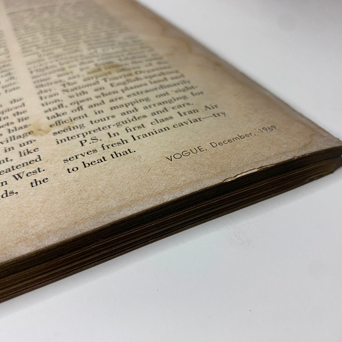 Page edge of Vogue Magazine December 1969, revealing age-related wear and the magazine's distinct branding, enhancing its collectible nature.