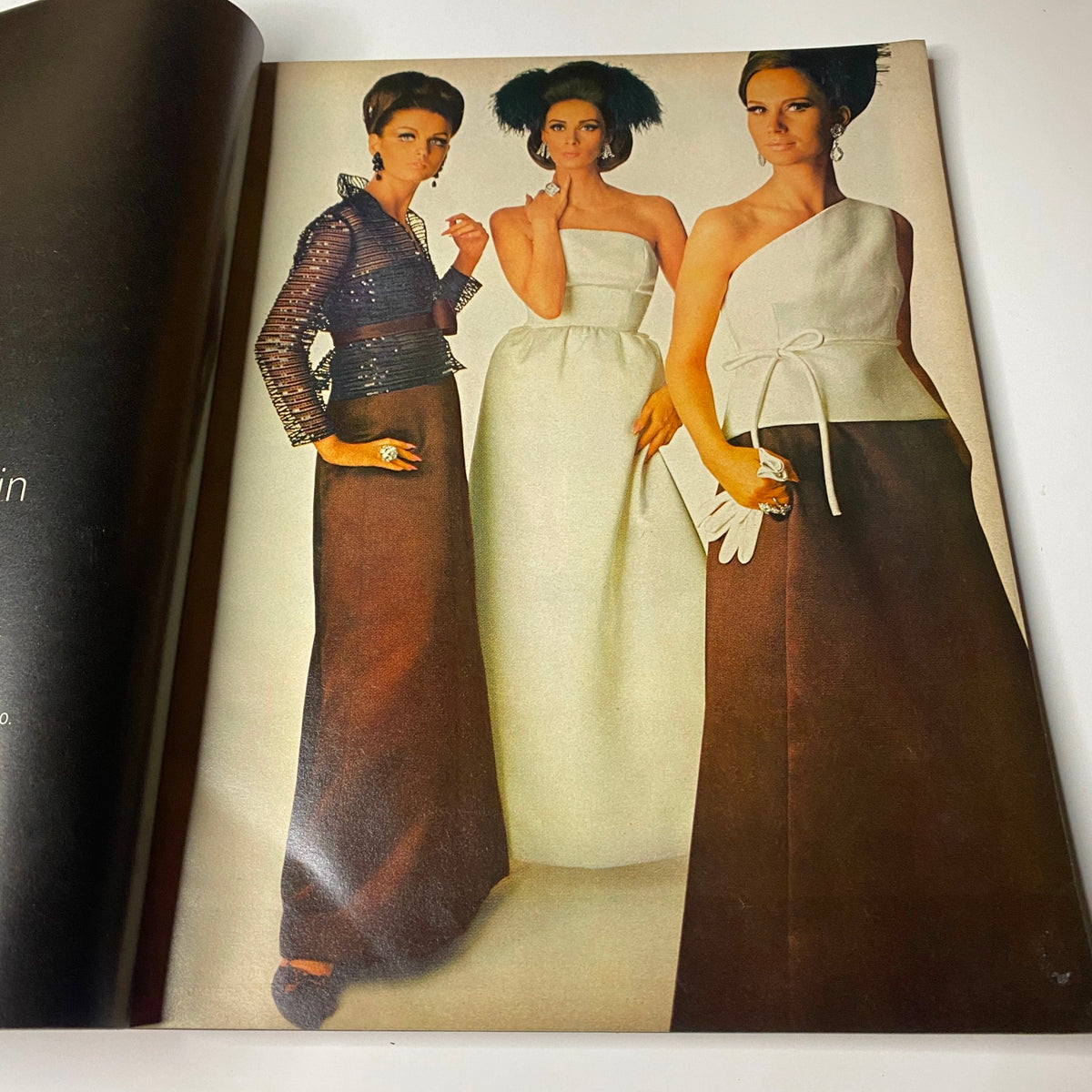 Fashion editorial page from Vogue Magazine October 1, 1965 displaying models in elegant evening wear, highlighting mid-sixties fashion with a refined aesthetic.