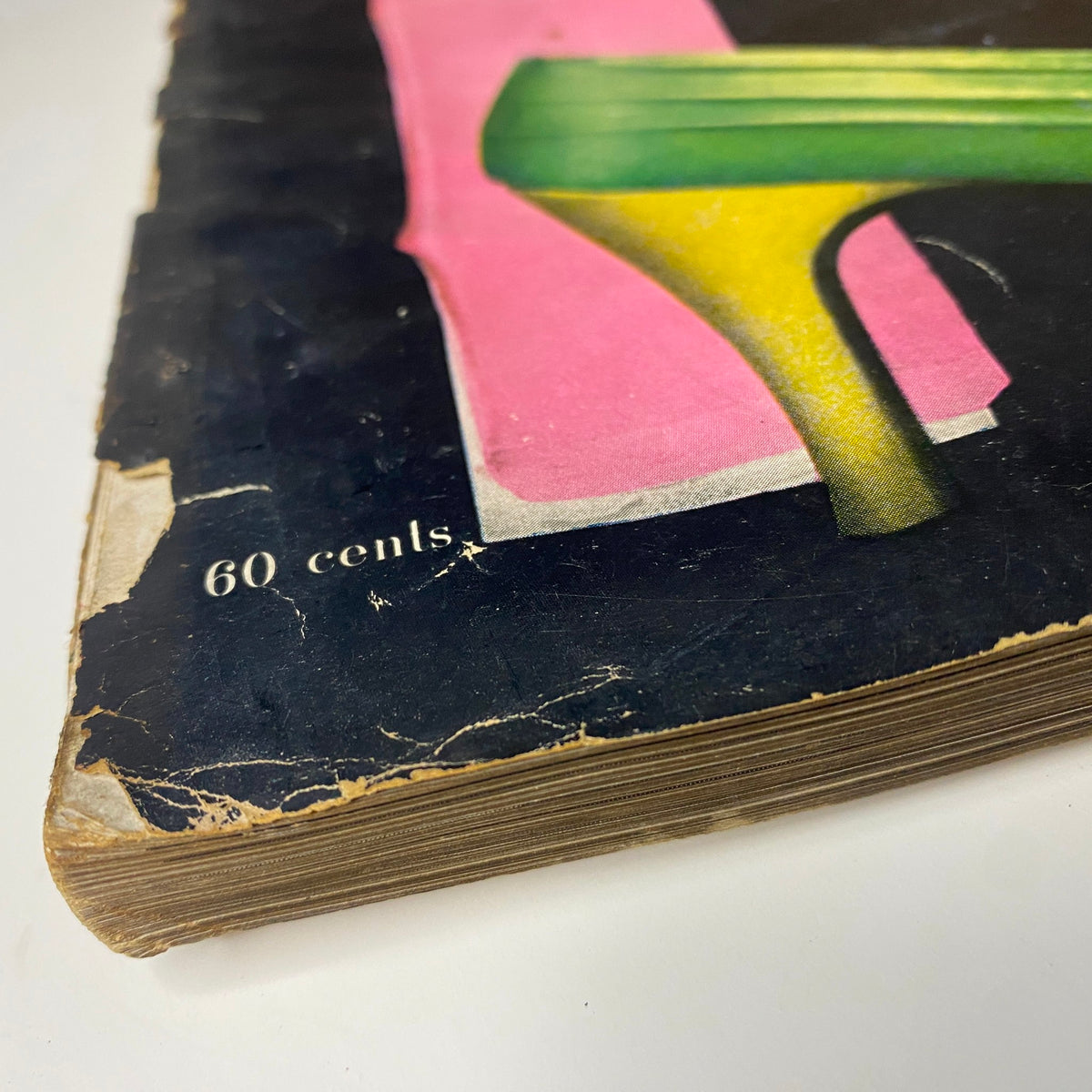 The worn cover of Harper's Bazaar Magazine September 1955 showing a vibrant pink and green high heel with visible wear and a price of 60 cents.
