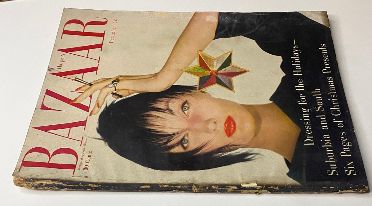Close-up view of Harper's Bazaar Magazine December 1955 cover, highlighting Evelyn Tripp adorned with a star-shaped ornament, embodying festive elegance.