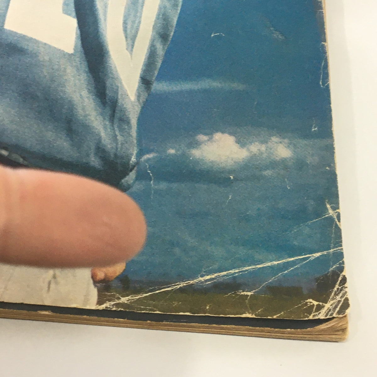 Detailed view of the Sports Illustrated Magazine August 17, 1964 depicting the lower edge of the cover with some minor wear, adding character to this collectible.