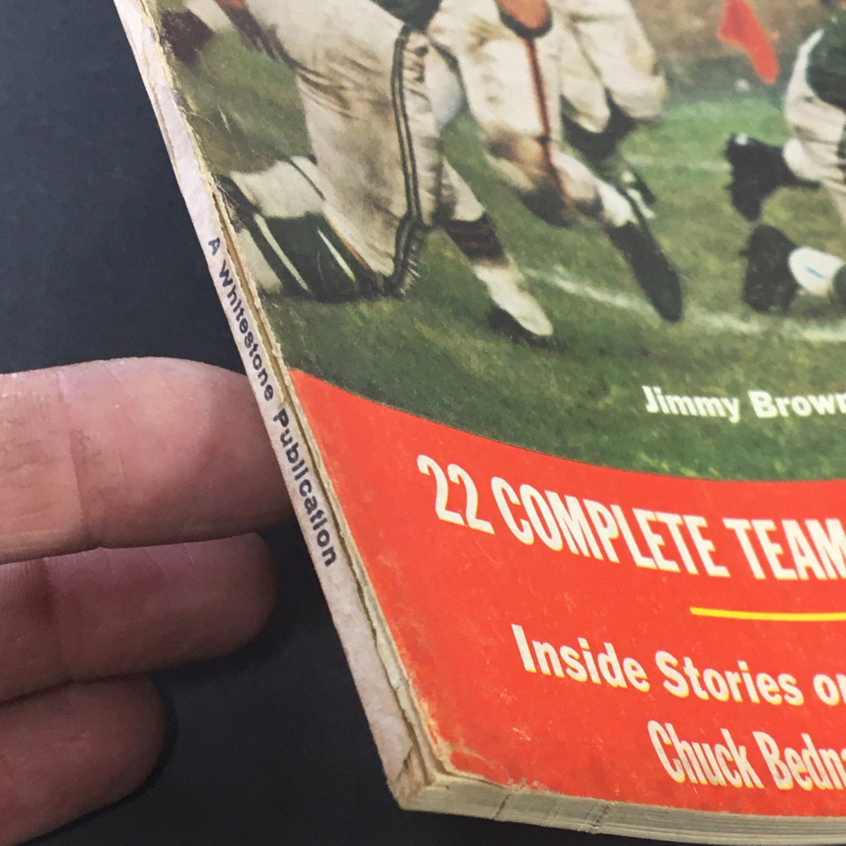 Side view of VTG Pro Football Stars Magazine 1961, highlighting the spine, edge wear, and the text '22 Complete Team Previews and Predictions'.