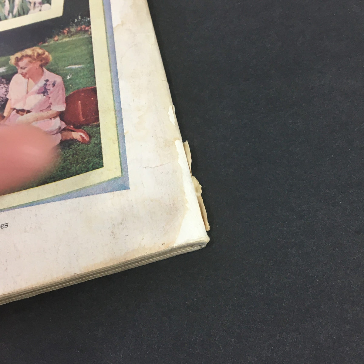 Detailed view of the edge of the back cover of The Saturday Evening Post April 10, 1951 showing minor wear and tear.