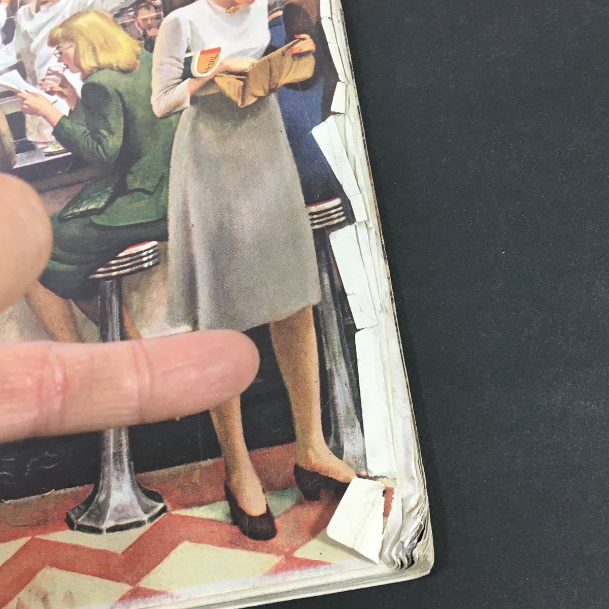 Detail of the front cover of VTG The Saturday Evening Post October 12 1946 with a focus on a woman reading and a man gesturing at a diner.