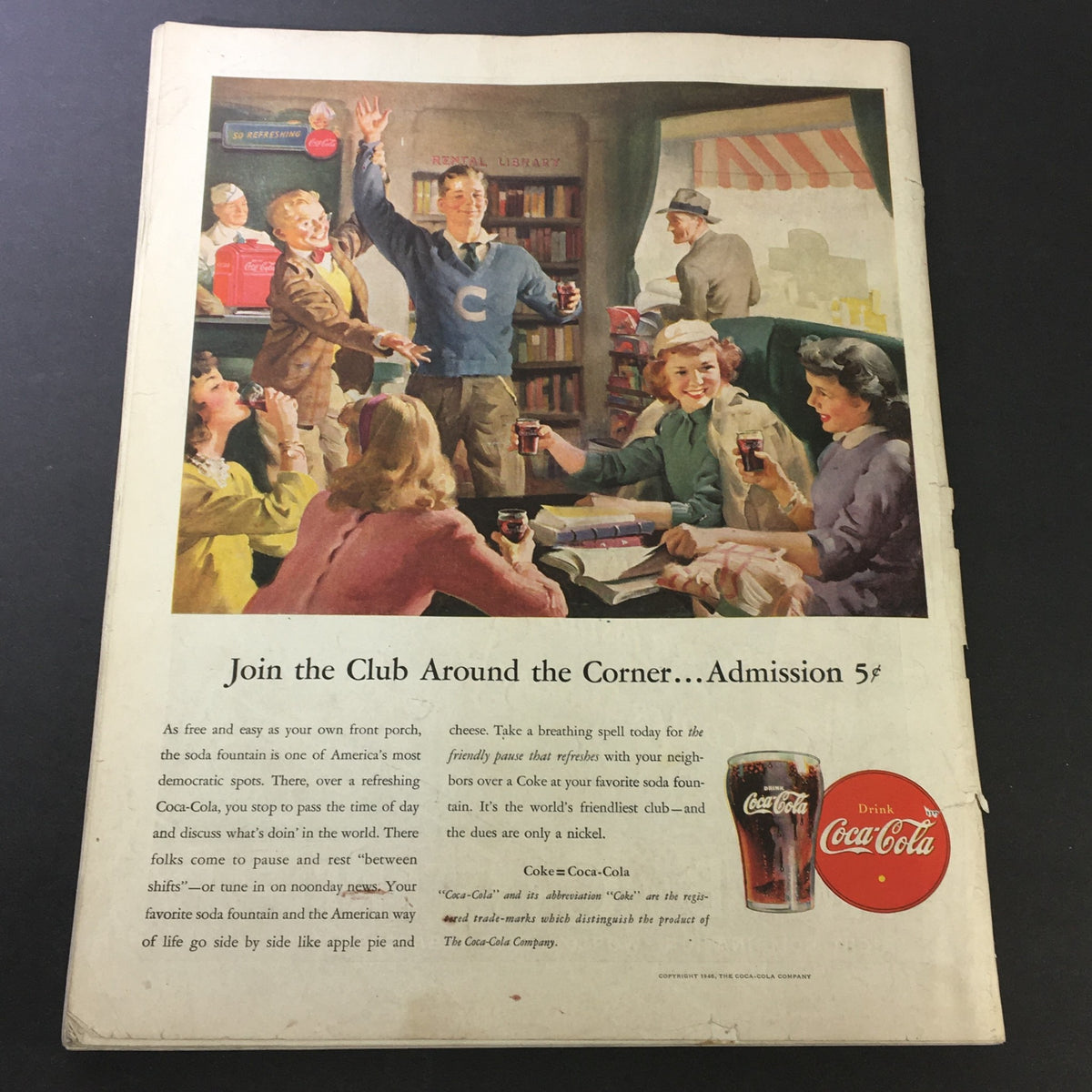 Vintage advertisement from The Saturday Evening Post, October 12, 1946 showing a lively scene of a soda fountain with young people enjoying Coca-Cola, promoting community and social interaction. Featuring the title 'Join the Club Around the Corner... Admission 5¢'.