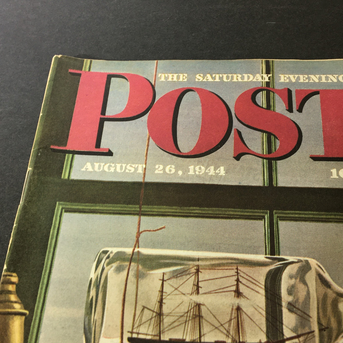 Close-up of the VTG The Saturday Evening Post August 26 1944 magazine cover, highlighting the prominent title and the details of the art, including a ship in a bottle and nautical elements.