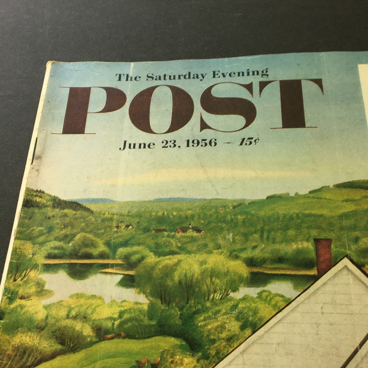Close-up of the vintage magazine cover of The Saturday Evening Post from June 23, 1956, showcasing the title and date with a picturesque landscape background.