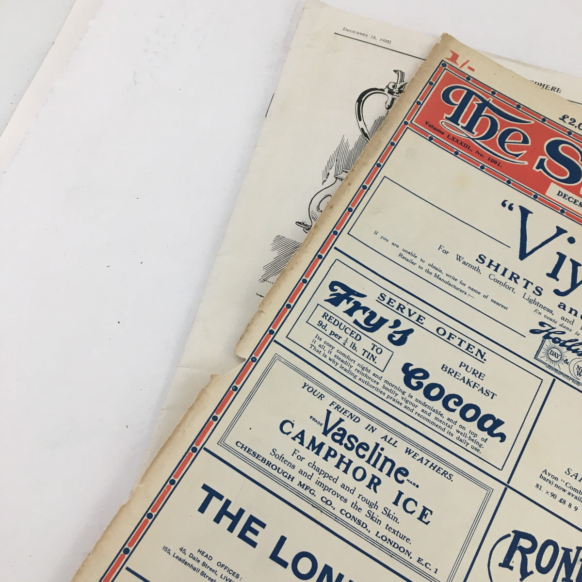 The Sphere Newspaper December 18 1920 showcasing an angled view of the front page, highlighting the title and advertisements.