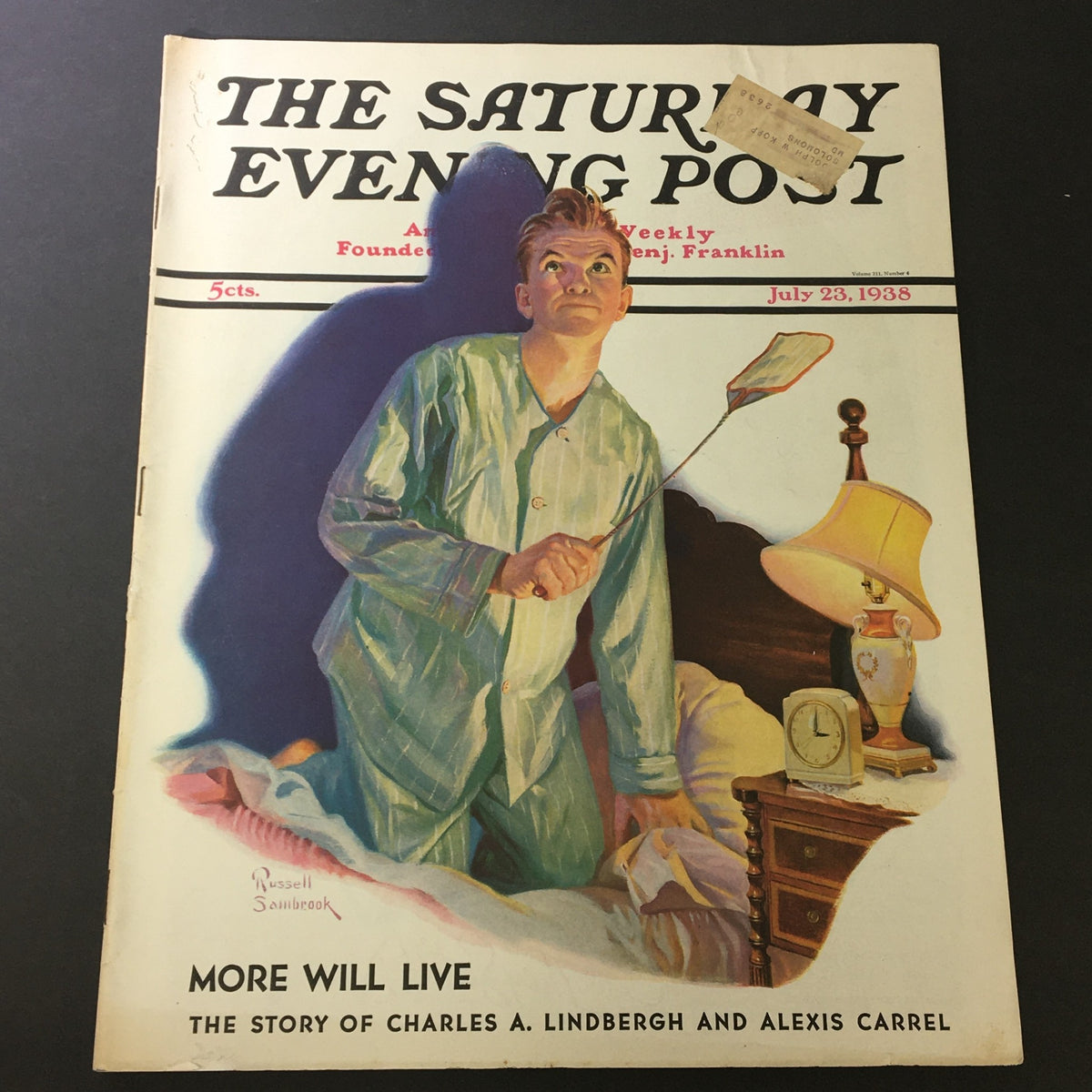 Cover of The Saturday Evening Post from July 23, 1938, featuring artwork by Russell Sambrook, depicting a young boy in pajamas holding a fly swatter beside a lamp and clock, titled "More Will Live: The Story of Charles A. Lindbergh and Alexis Carrel".