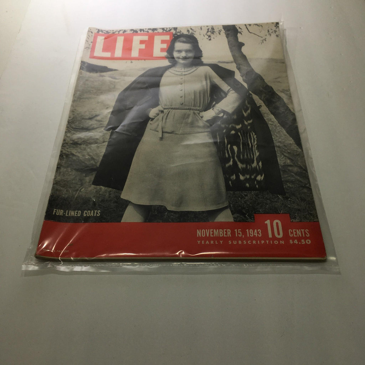 Cover of Life Magazine: November 15, 1943 showcasing fur-lined coats with a model posing, highlighting mid-20th century fashion trends.