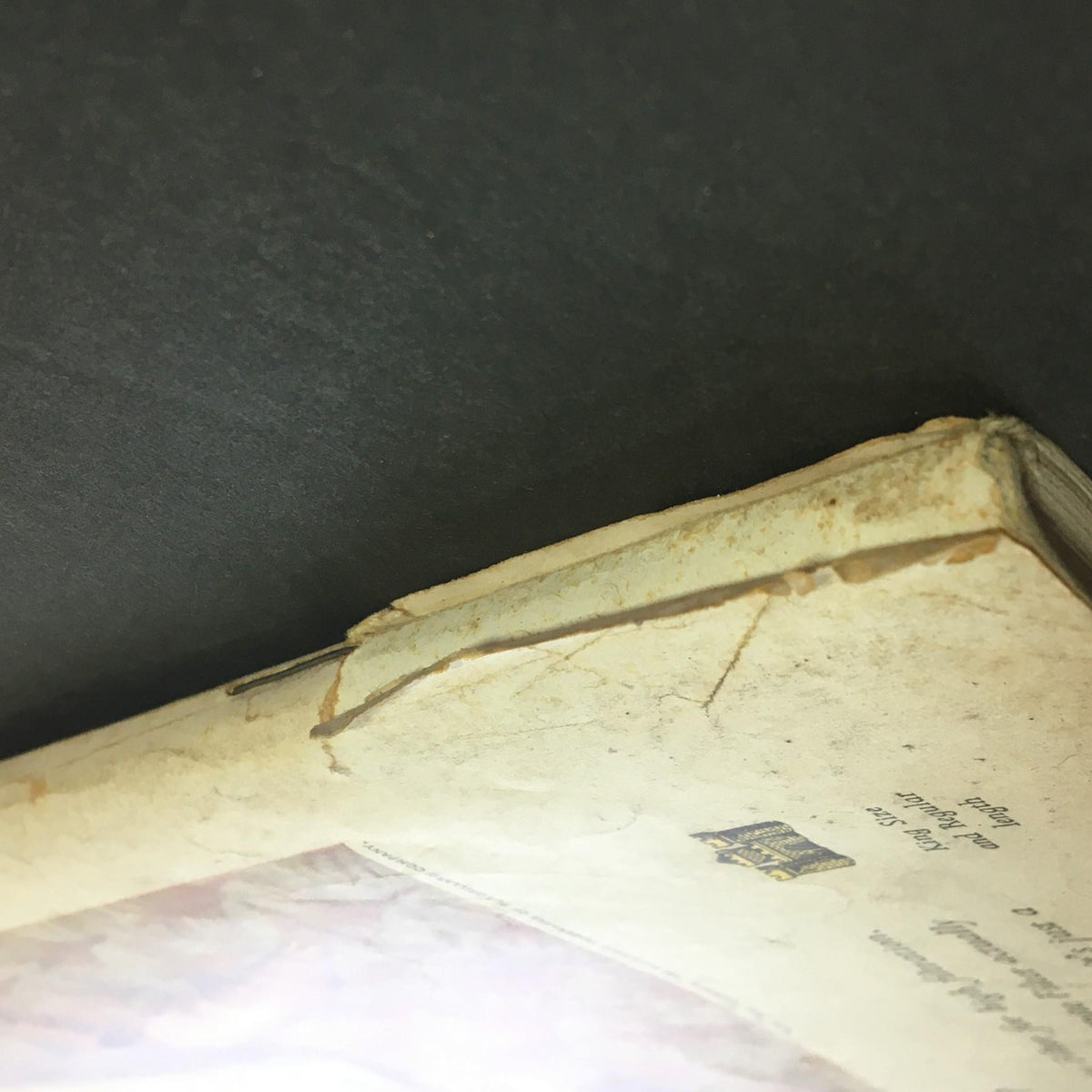 Close-up of the top edge of the back cover of the Saturday Evening Post April 14, 1956 showing signs of wear and age.