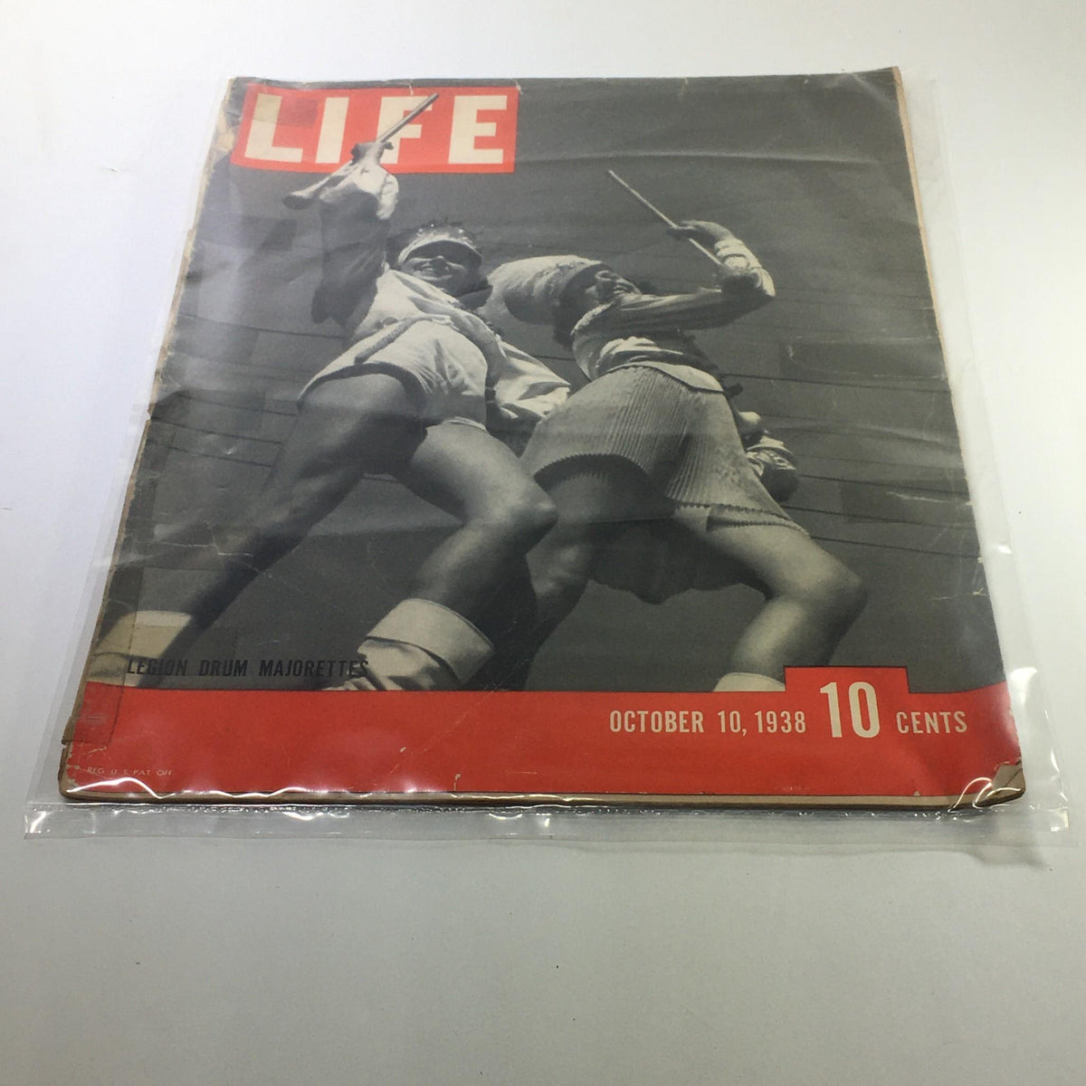 Cover of Life Magazine from October 10, 1938, featuring Legion Drum Majorettes. The image showcases two drum majorettes in mid-performance, portraying a vibrant moment in American culture during the 1930s, with the magazine title prominently displayed.