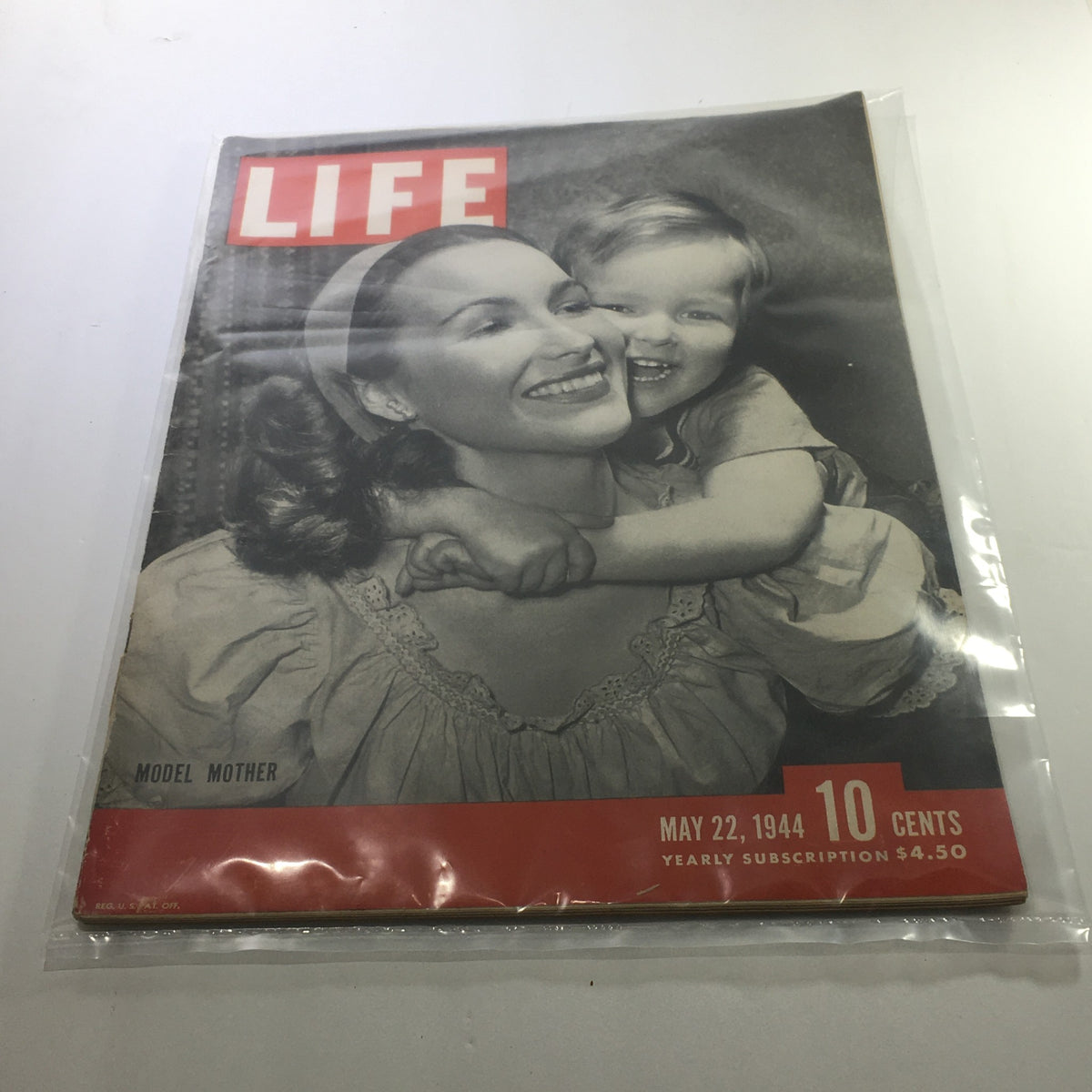 Cover of Life Magazine: May 22, 1944 - Model Mother featuring a smiling mother and child, highlighting the significance of women's roles during World War II.