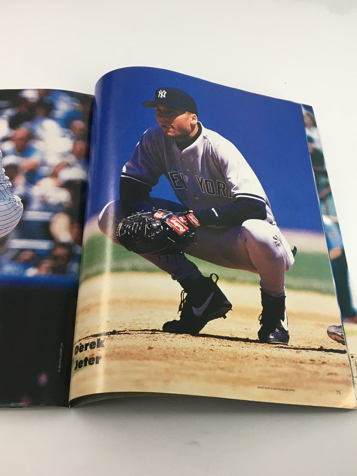 Derek Jeter crouching on the field featured in the 1996 Gold Collectors Series Magazine, highlighting his early career with the New York Yankees.