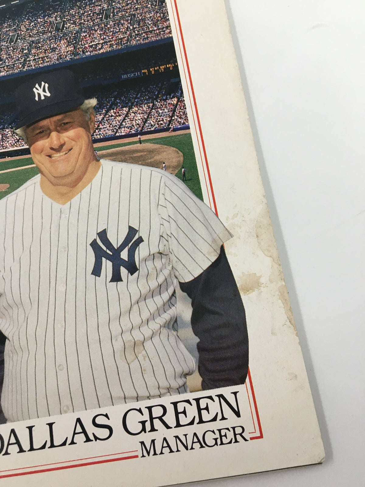 Close-up of the 1989 New York Yankees Scorebook & Souvenir Program, highlighting Dallas Green in a Yankees uniform with the stadium in the background.