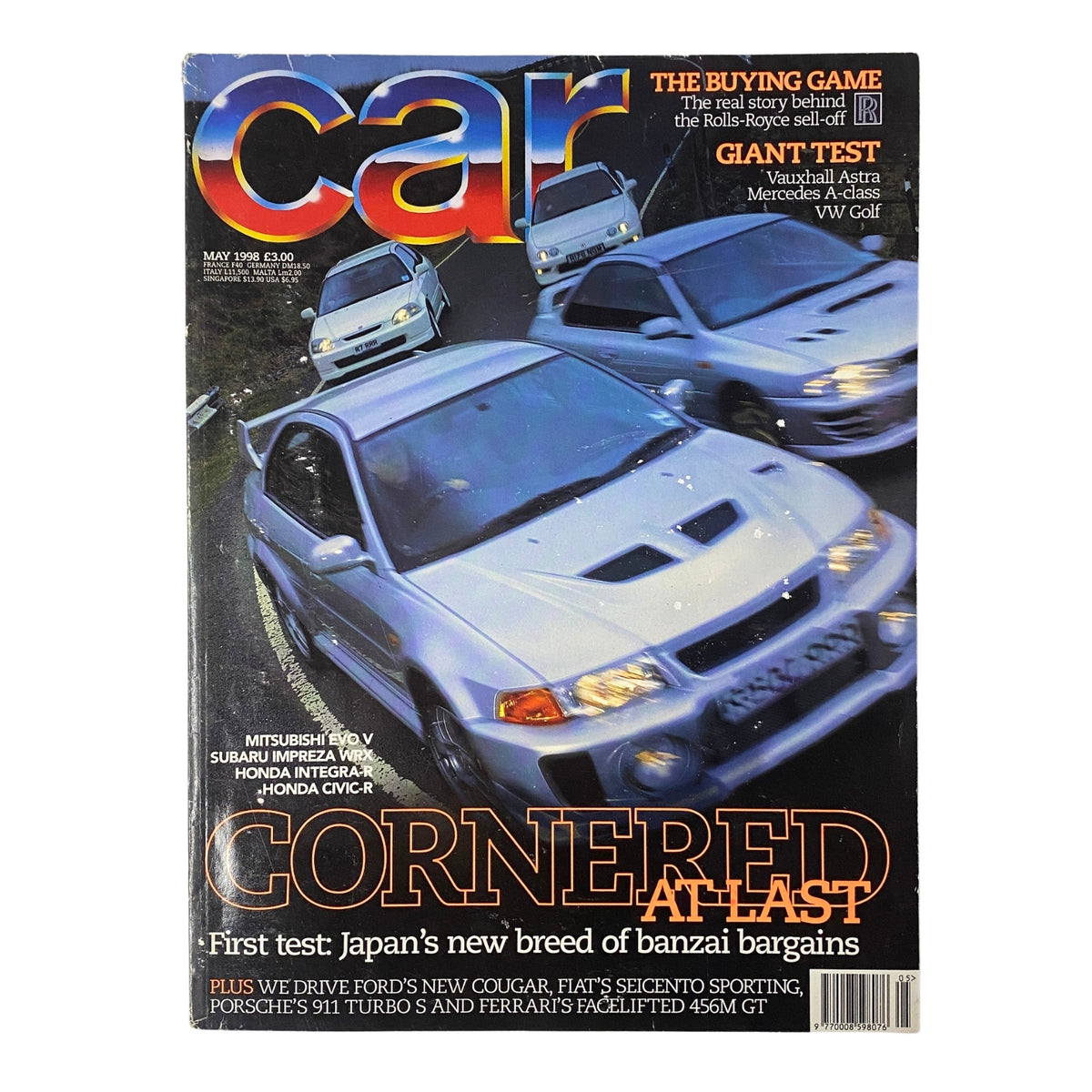 Cover of Car Magazine UK May 1998 featuring Mitsubishi Evo vs Subaru Impreza WRX & Honda Integra-R, showcasing cars in motion with the title 'Cornered at Last'.