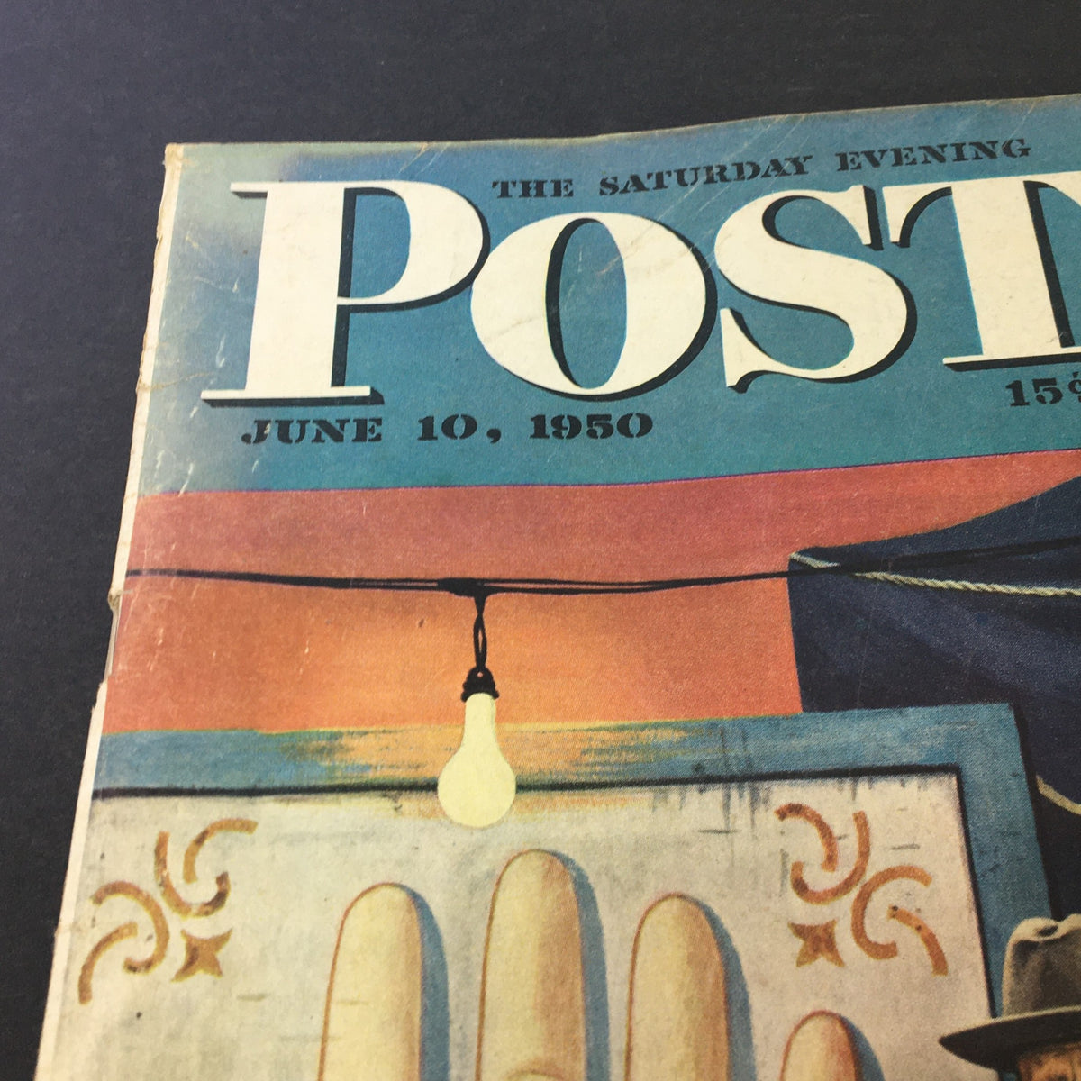 Close-up view of The Saturday Evening Post June 10 1950 cover highlighting the magazine title and date with a bright light bulb and palm reading illustration.