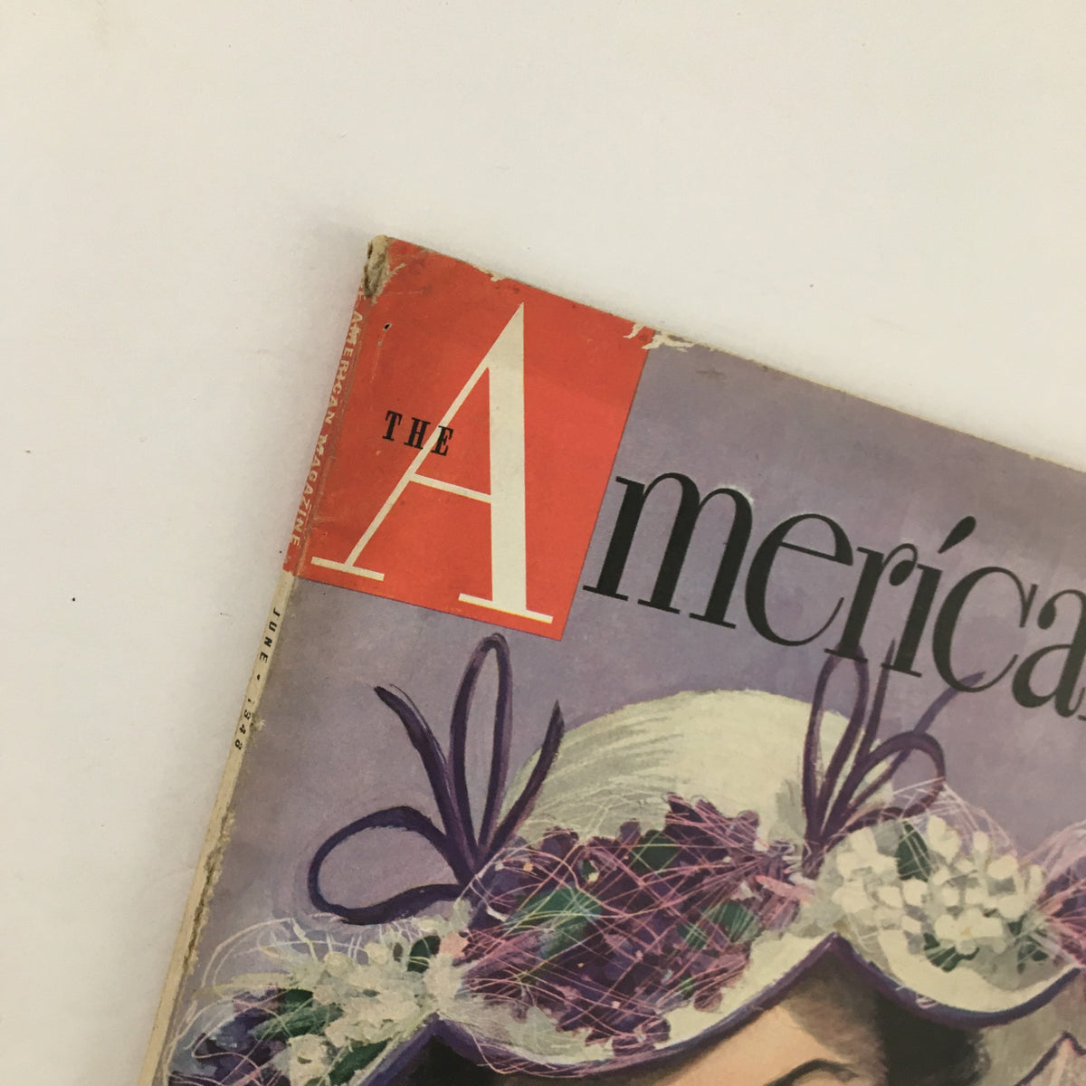 Top portion of the cover of The American Magazine June 1948, highlighting the iconic title and the fashionable hat worn by a woman, reflecting 1940s style.