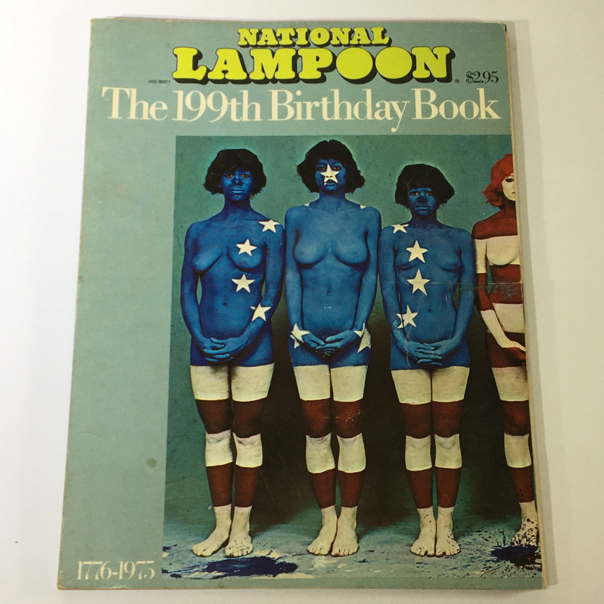 Cover of the 1776-1975 National Lampoon 199th Birthday Book, featuring models painted in blue with white stars, celebrating the USA's birthday.