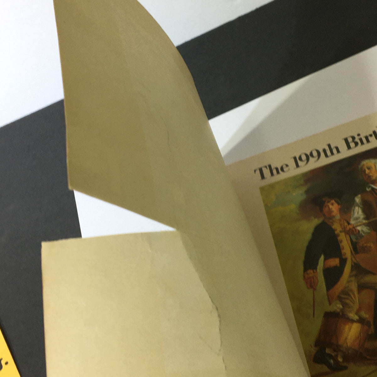 Inside page of the 1776-1975 National Lampoon 199th Birthday Book, showing a folded paper with minor wear, symbolizing the book's vintage character.
