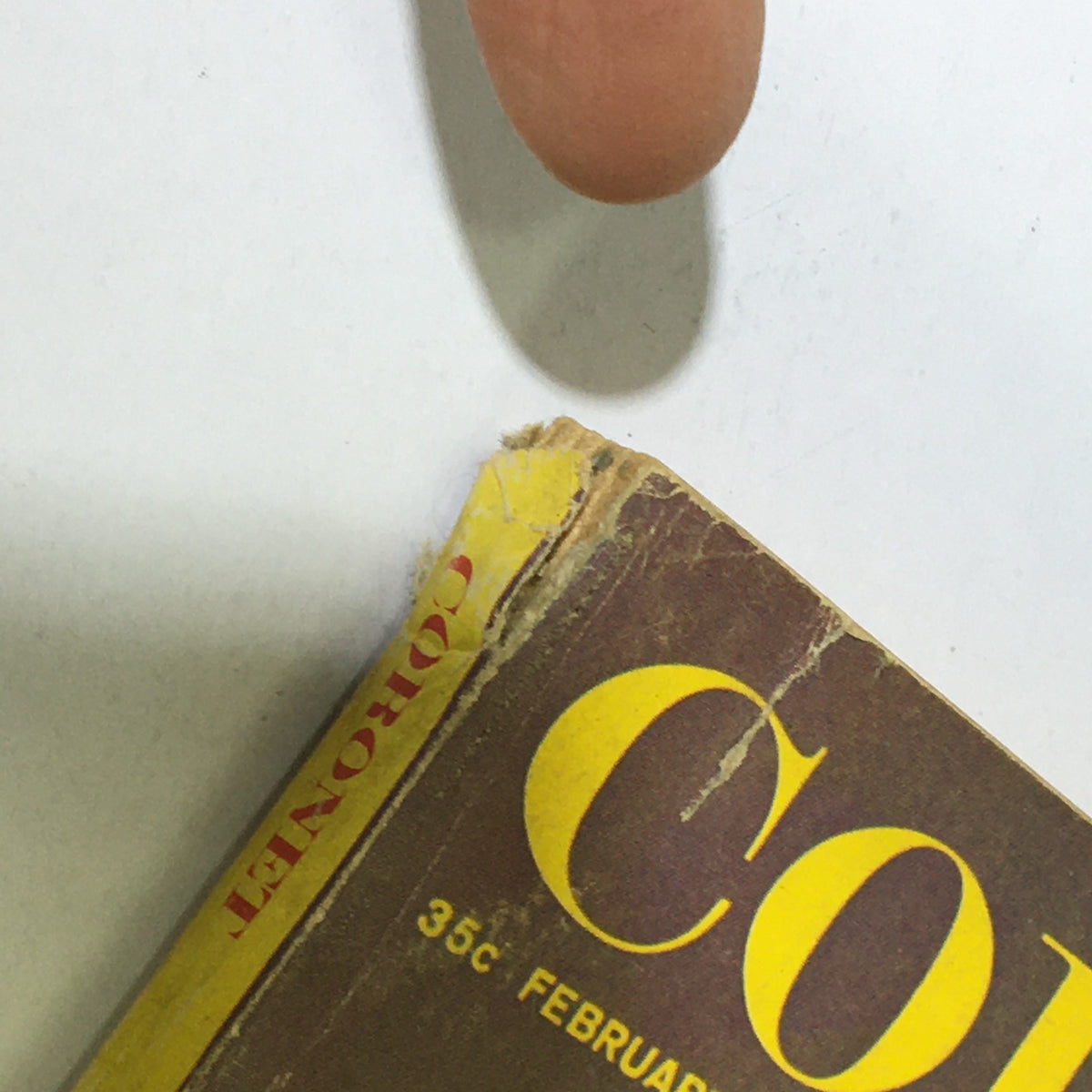 Corner detail of the VTG Coronet Magazine February 1961 featuring Marilyn Monroe, highlighting slight damage and the magazine title clearly visible.