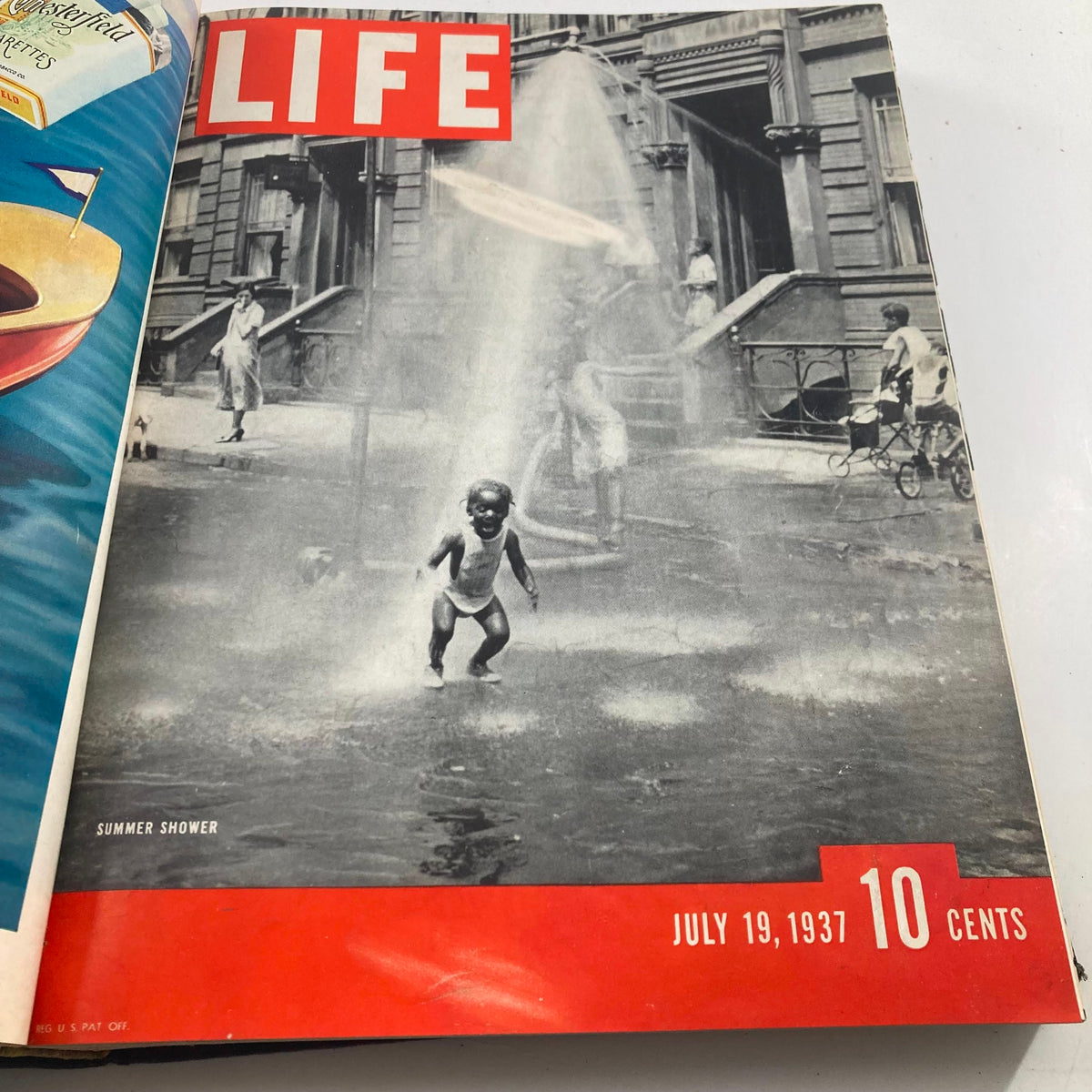 Cover of VTG 1937 Bound Life Magazine July 19 depicting a joyful child enjoying a summer shower, illustrating 1930s street life.