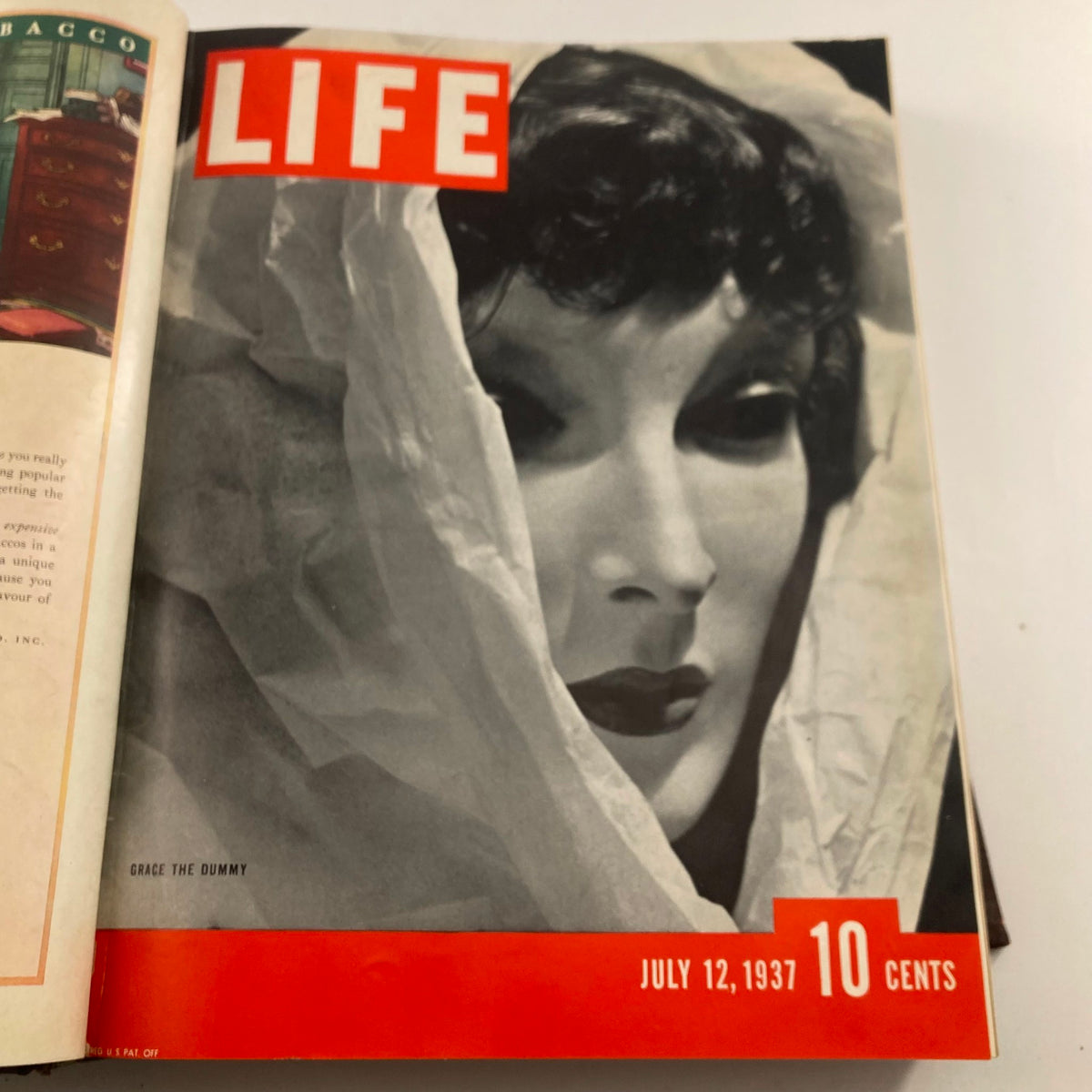 Open page of the VTG 1937 Bound Life Magazine with the cover for July 12, 1937, depicting Grace the Dummy in an artistic photo.