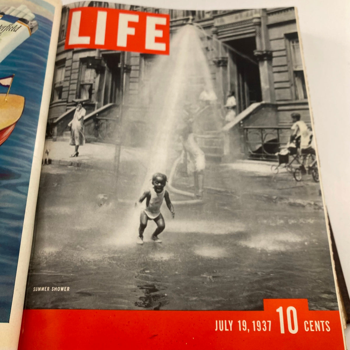 VTG 1937 Bound Life Magazine Cover featuring a child playing in a summer shower, dated July 19, 1937.