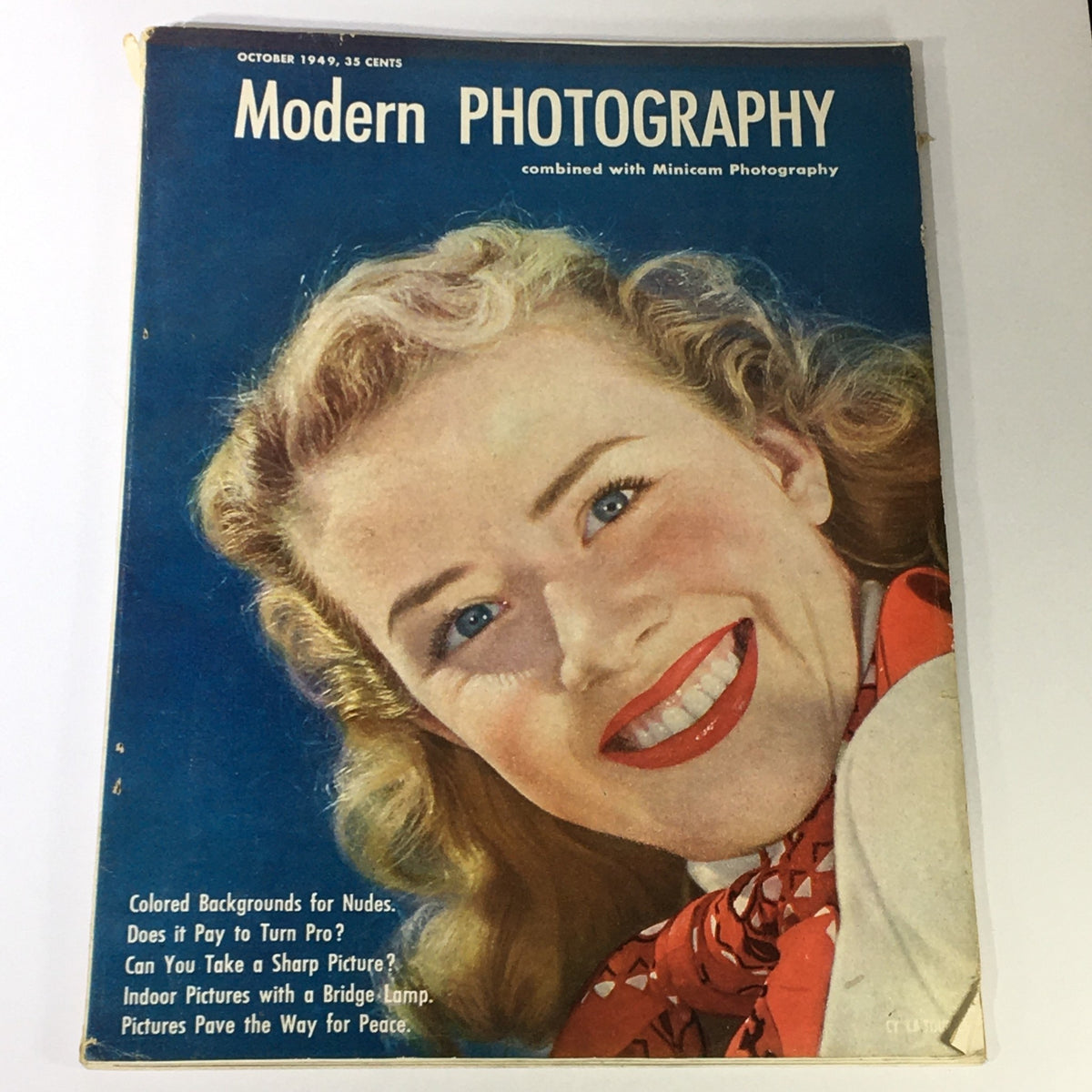 VTG Modern Photography October 1949 magazine cover featuring a smiling woman, showcasing the aesthetic of mid-20th century photography.