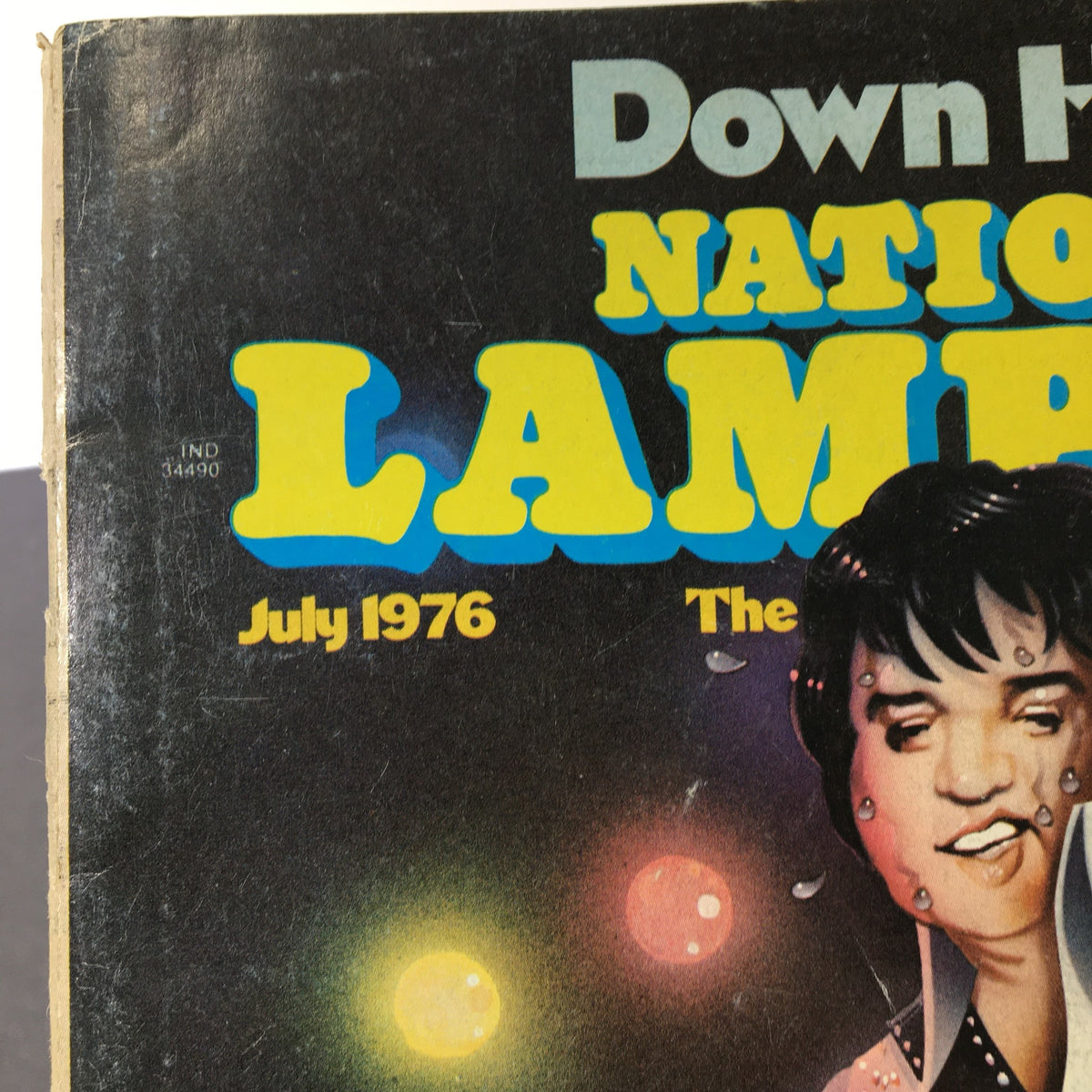 Close-up of July 1976 National Lampoon Magazine cover, highlighting the title and Elvis Presley caricature, capturing the spirit of 1970s pop culture.