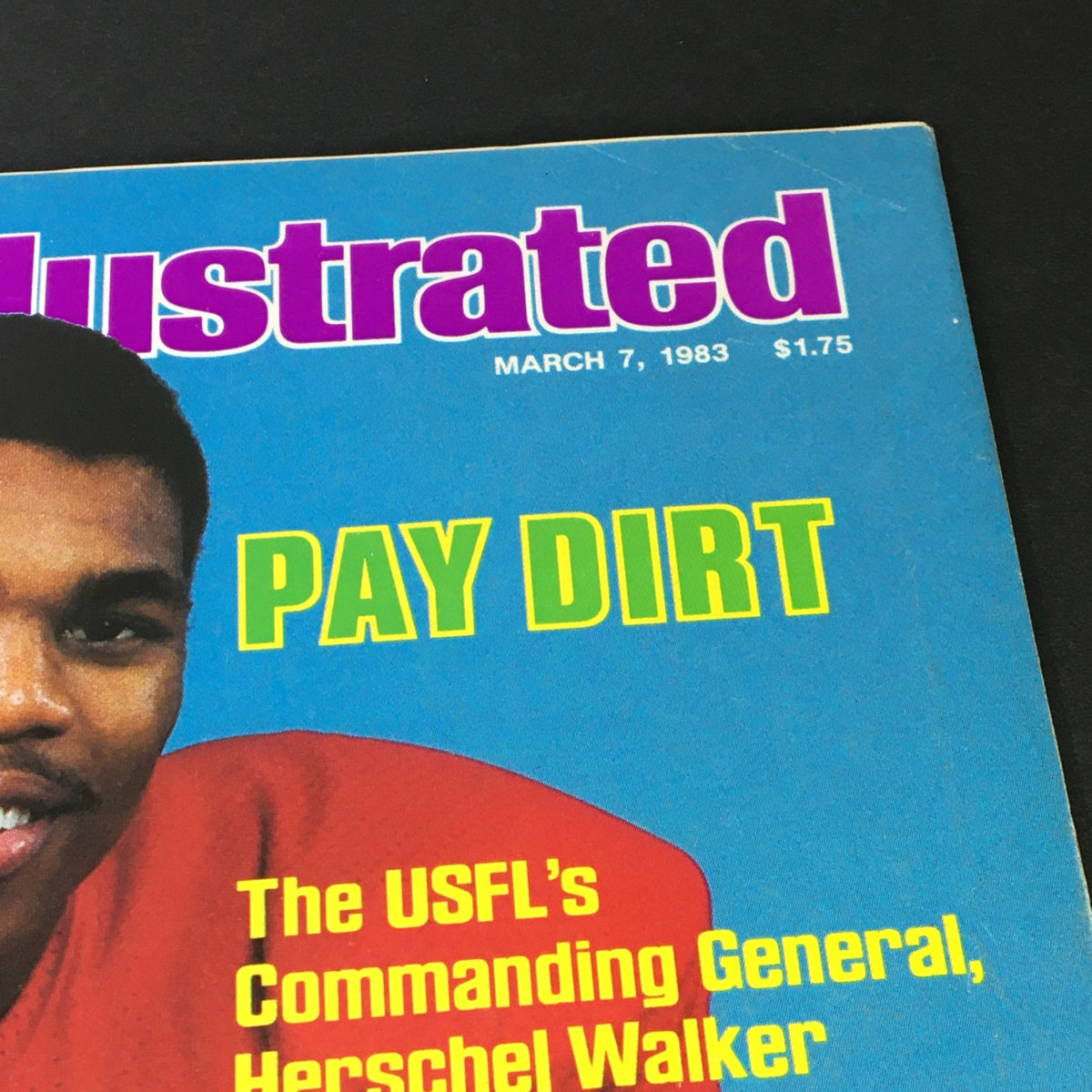 Close-up of the March 7, 1983, issue of Sports Illustrated magazine highlighting USFL's General Herschel Walker, emphasizing the title 'PAY DIRT' alongside his image.