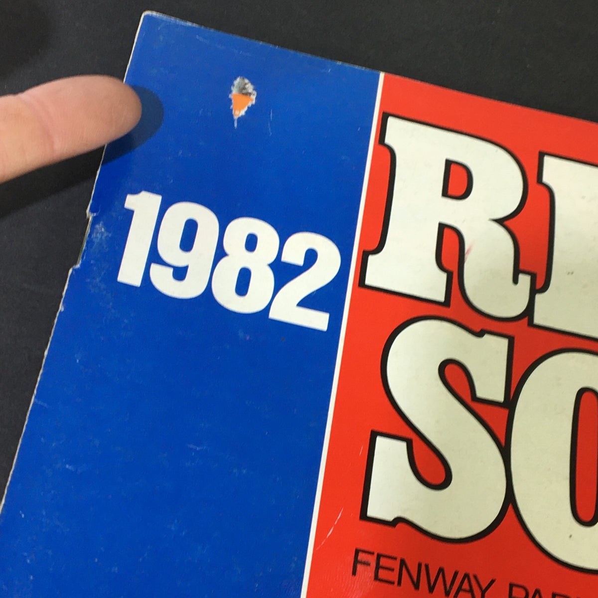 Close-up of the 1982 Boston Red Sox Scorebook cover showing minor wear, highlighting the publication's vintage condition.