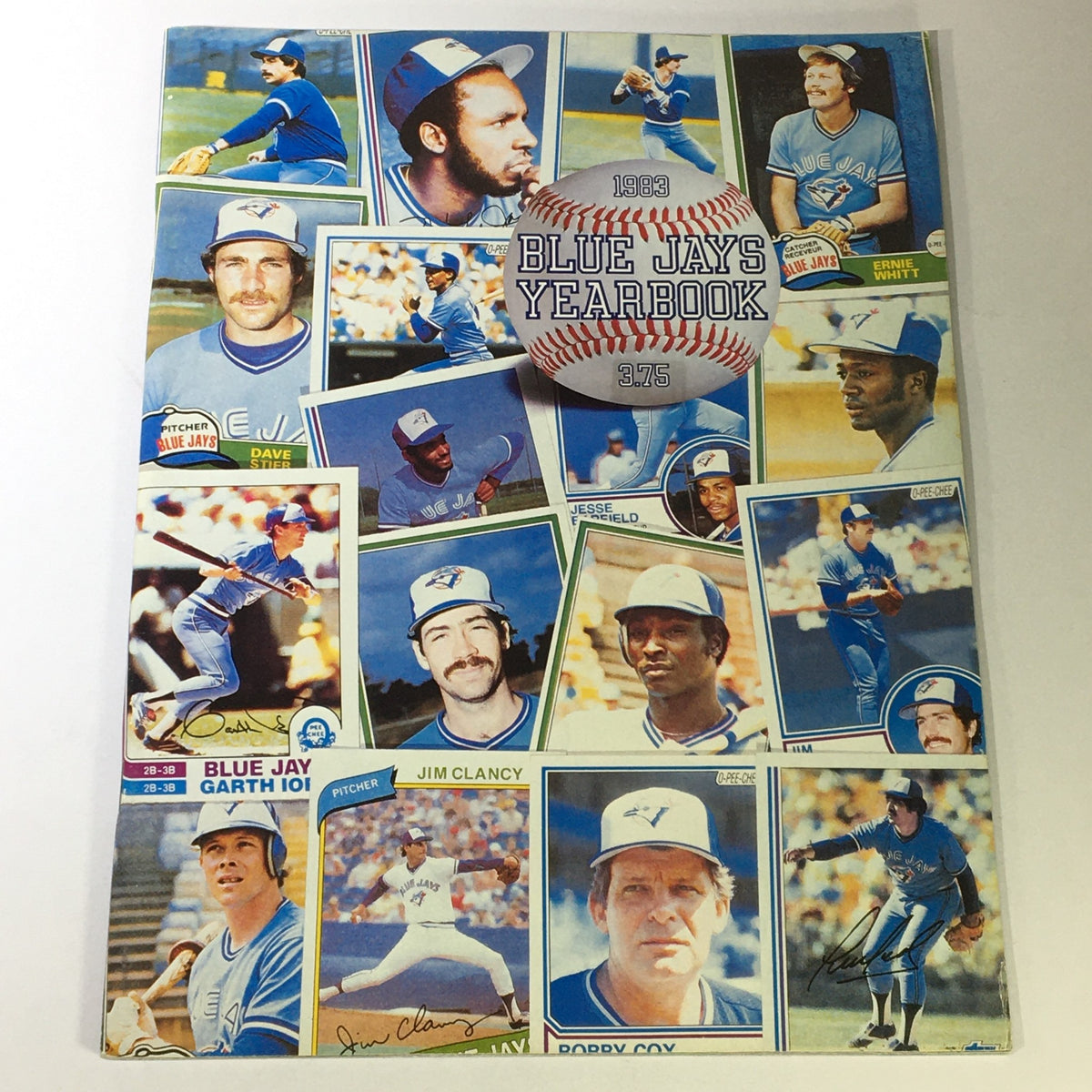 Vintage MLB Official Blue Jays Yearbook 1983 featuring players Jim Clancy, Dave Stier, and Ernie Whitt; cover showcases a collage of Blue Jays players with a baseball in the center.