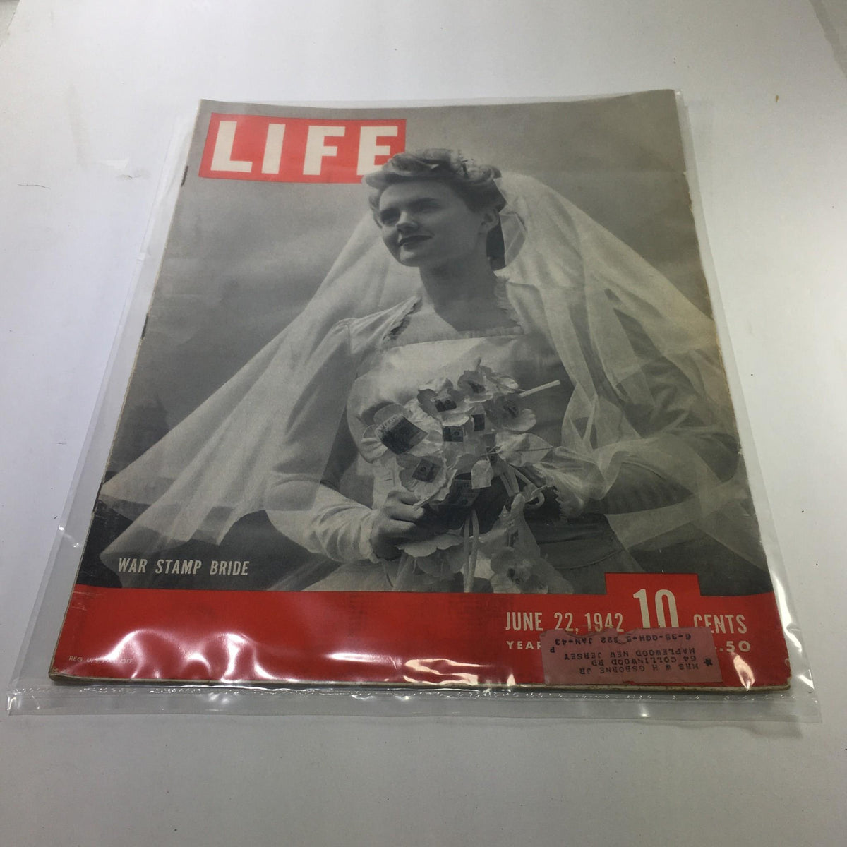 Cover of Life Magazine: June 22, 1942 - War Stamp Bride featuring a bride in a veil holding a bouquet, capturing the essence of World War II resilience.