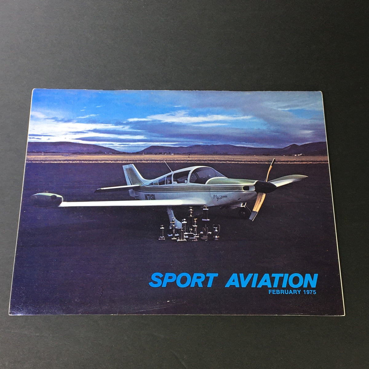Cover of Sport Aviation February 1975 Vol 24 #2 featuring a complete custom-built restored aircraft on an open landscape.